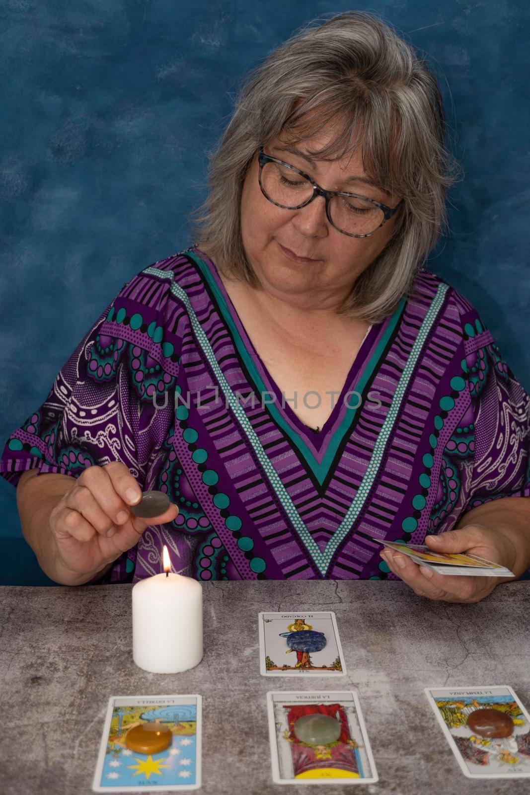 woman casting tarot cards by joseantona