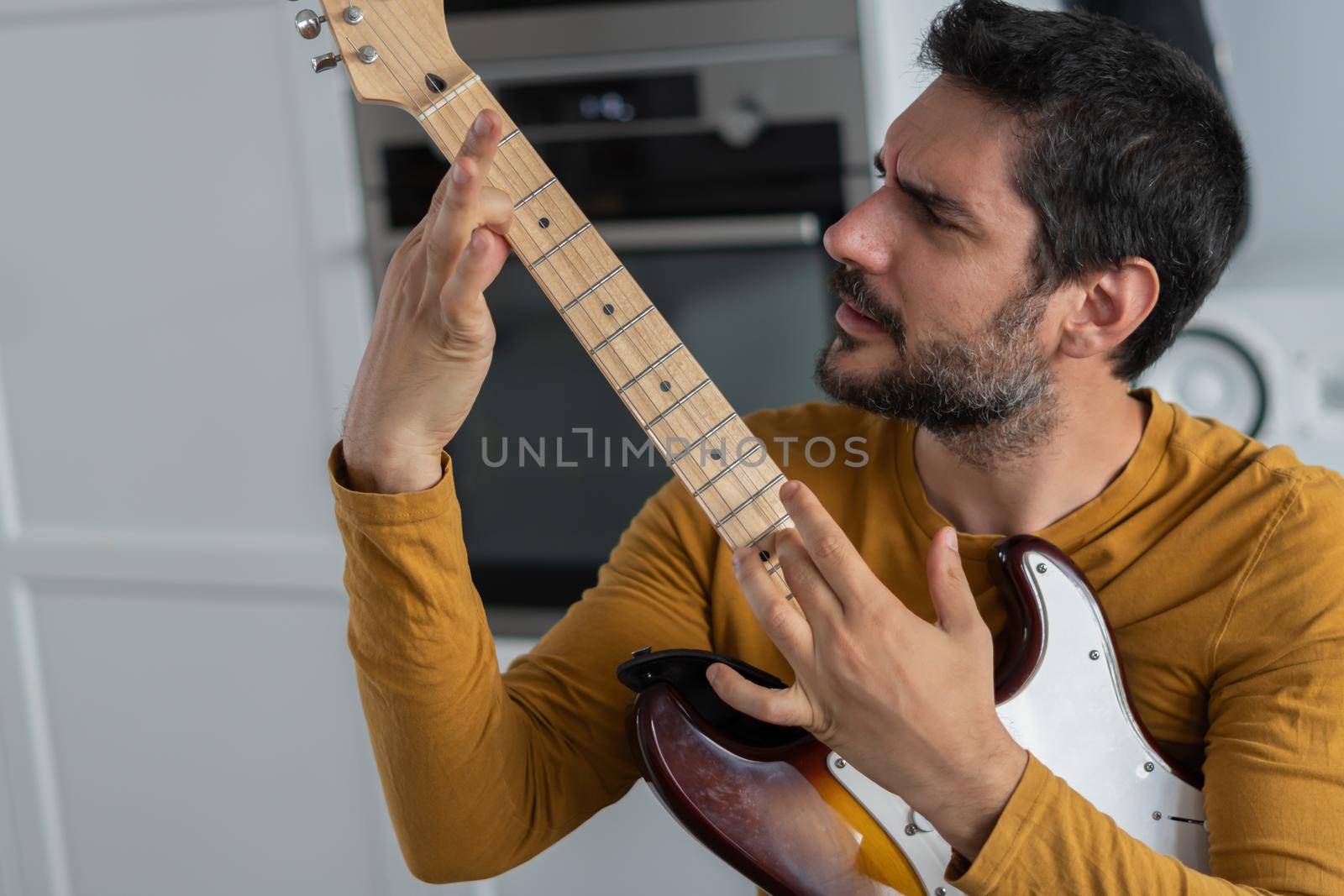 young man playing guitar by joseantona