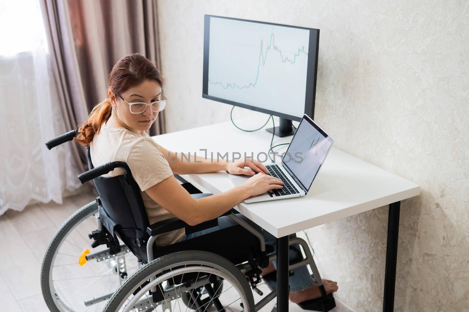 Caucasian woman on wheelchair working on laptop. by mrwed54