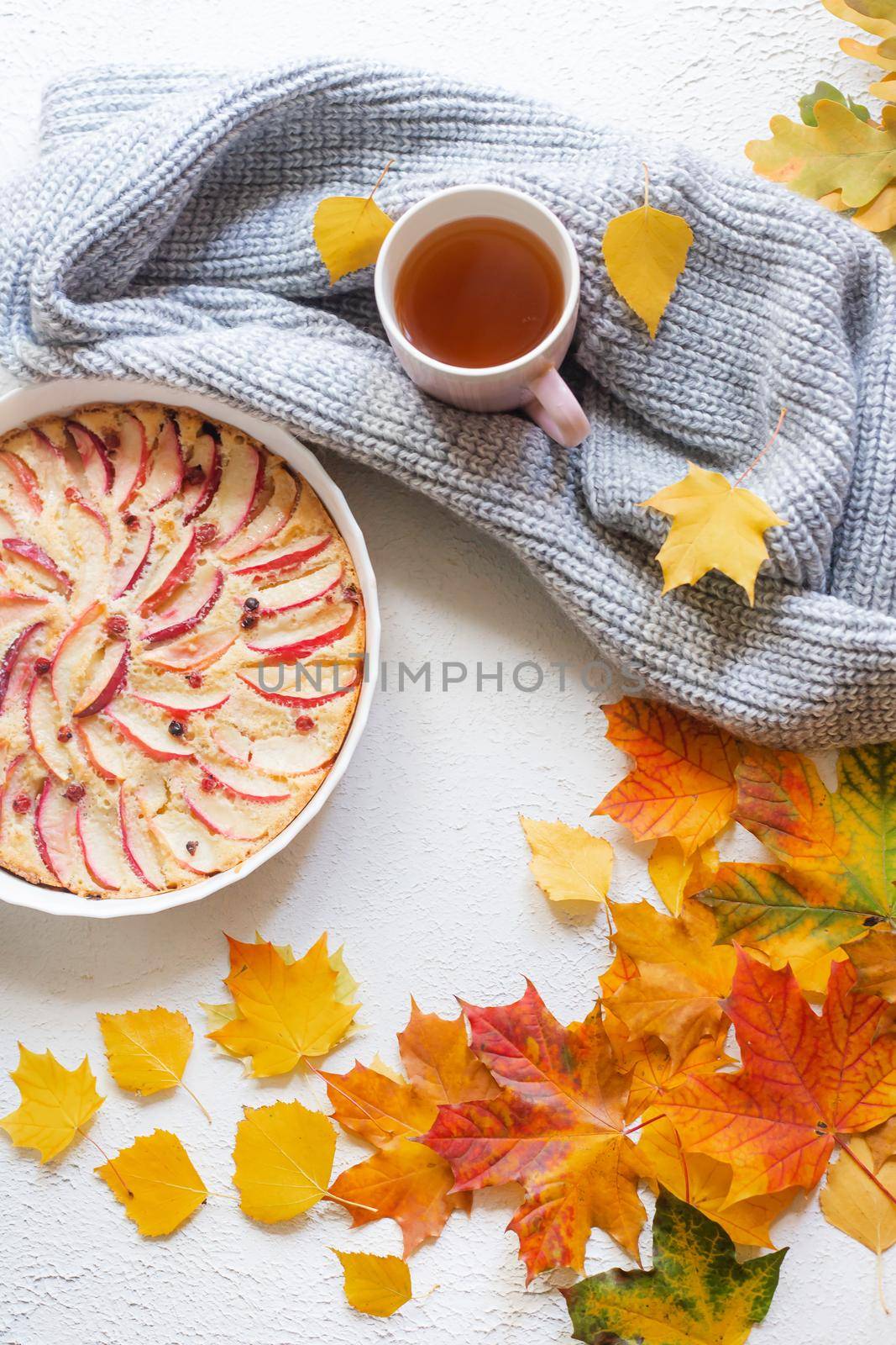 Apple pie layout and autumn leaves top view . An article about autumn. An article about baking. Homemade cakes. Autumn picture