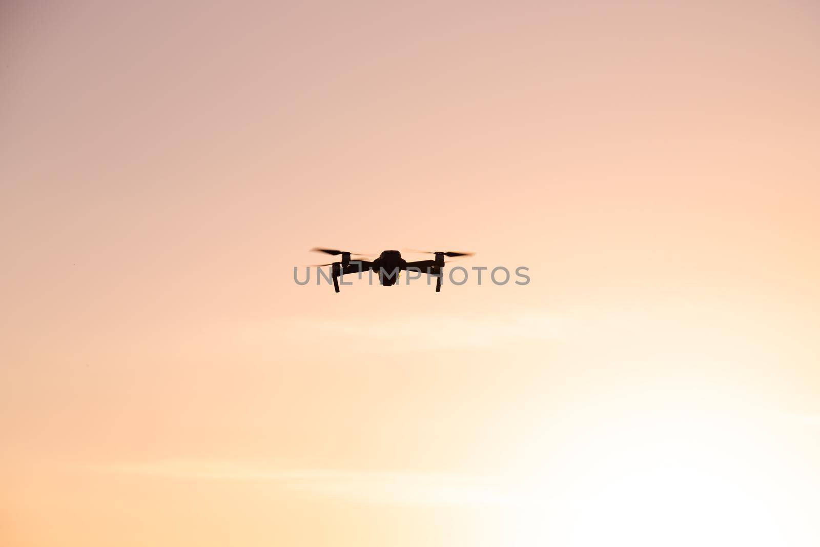 The drone is in flight at sunset . Video shooting from above. An article about the choice of a quadrocopter. Pros and cons of the drone. by alenka2194