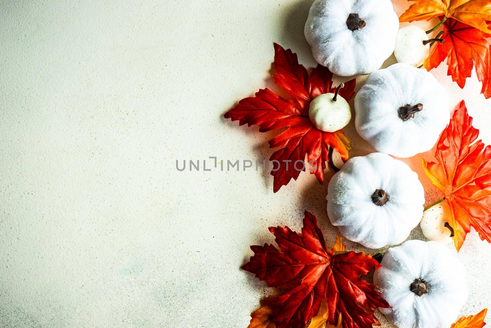 Fake maple leaves on the concrete background by Elet