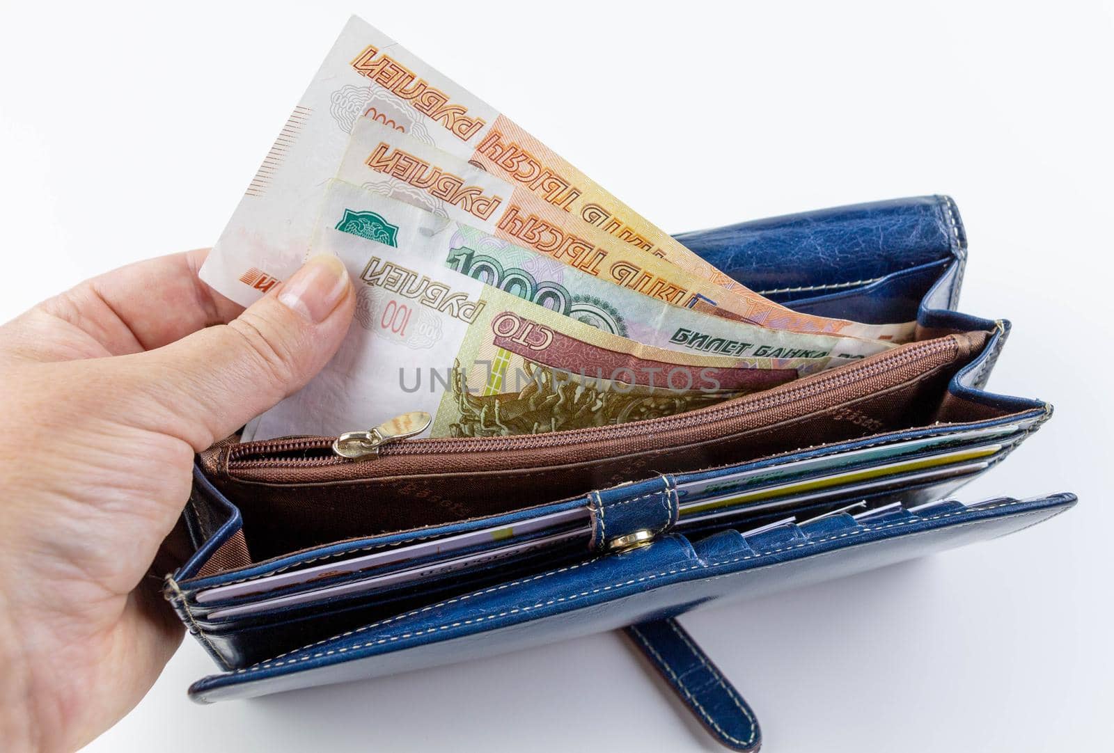 Leather blue wallet with Russian money. Hand hold paper money.