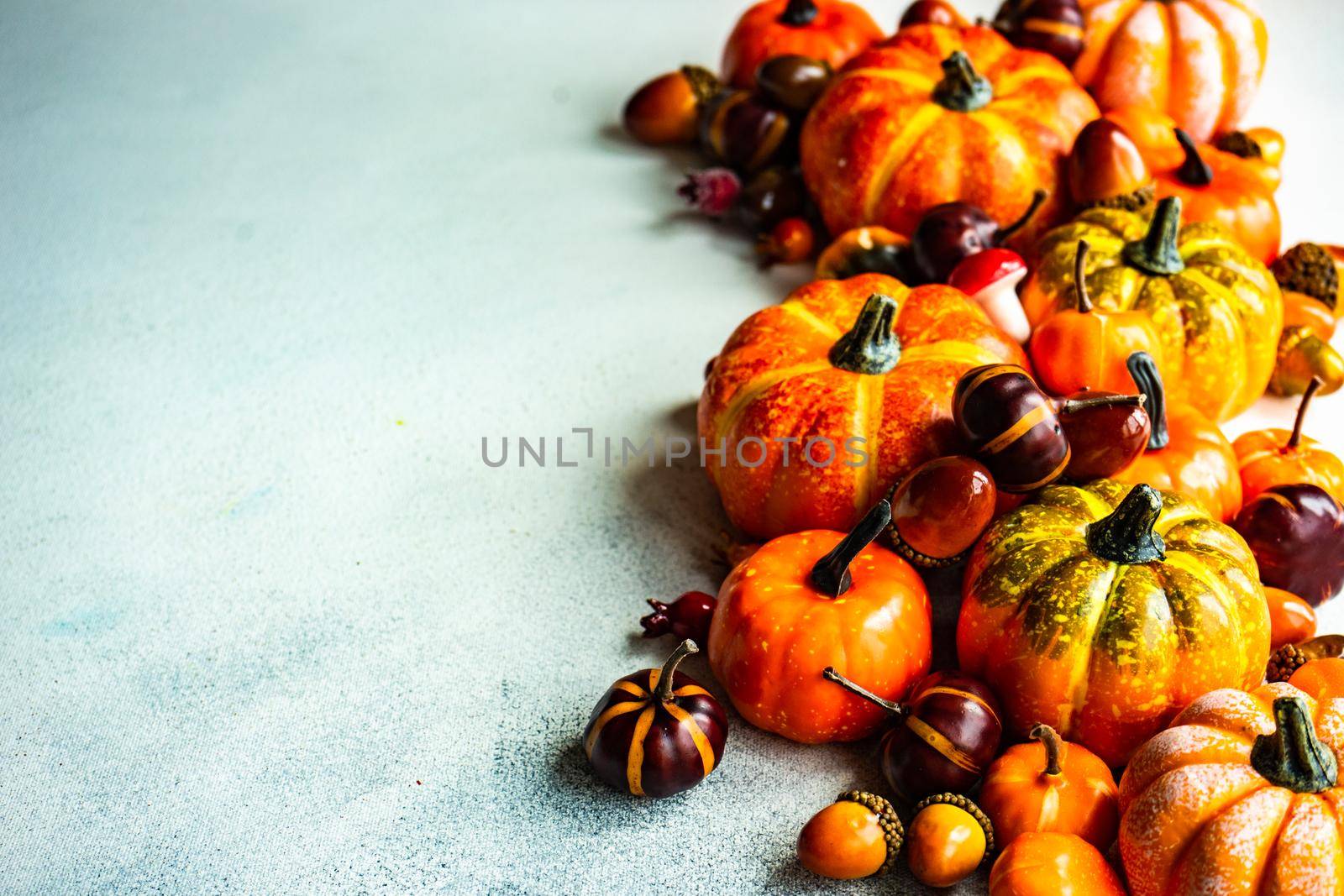 Autumnal frame concept with pumpkins on concrete background