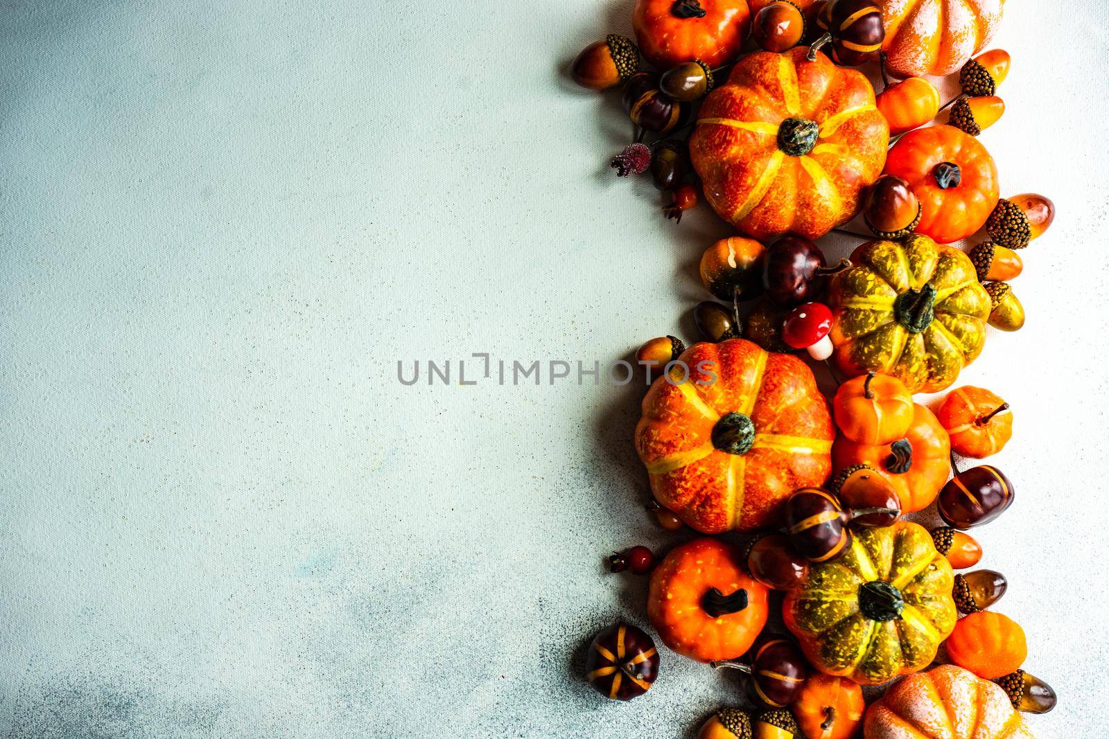 Autumnal frame concept with pumpkins on concrete background