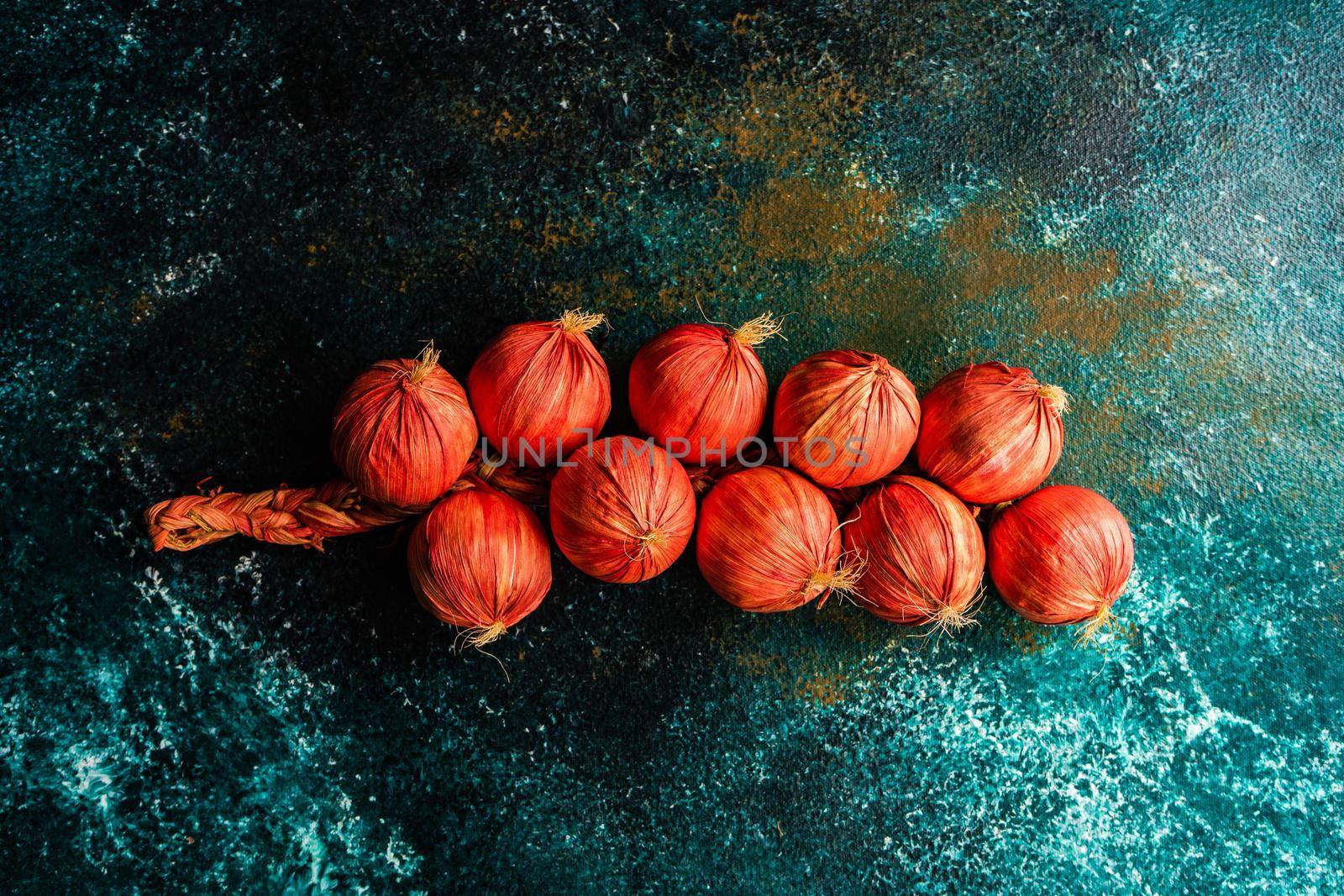 Red dry onion vegetables  as a autumnal harvest concept on concrete background
