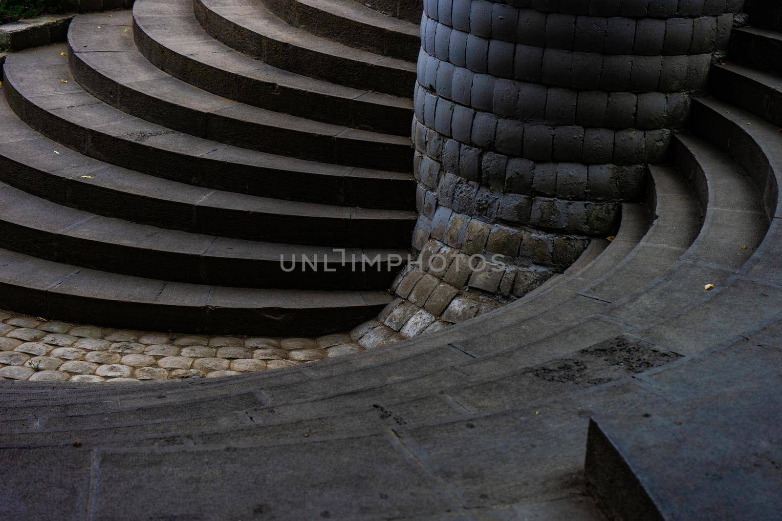 Spiral stairs in the park made with grey bricks