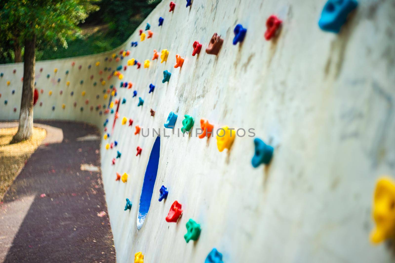 Kid climbing wall in the park by Elet