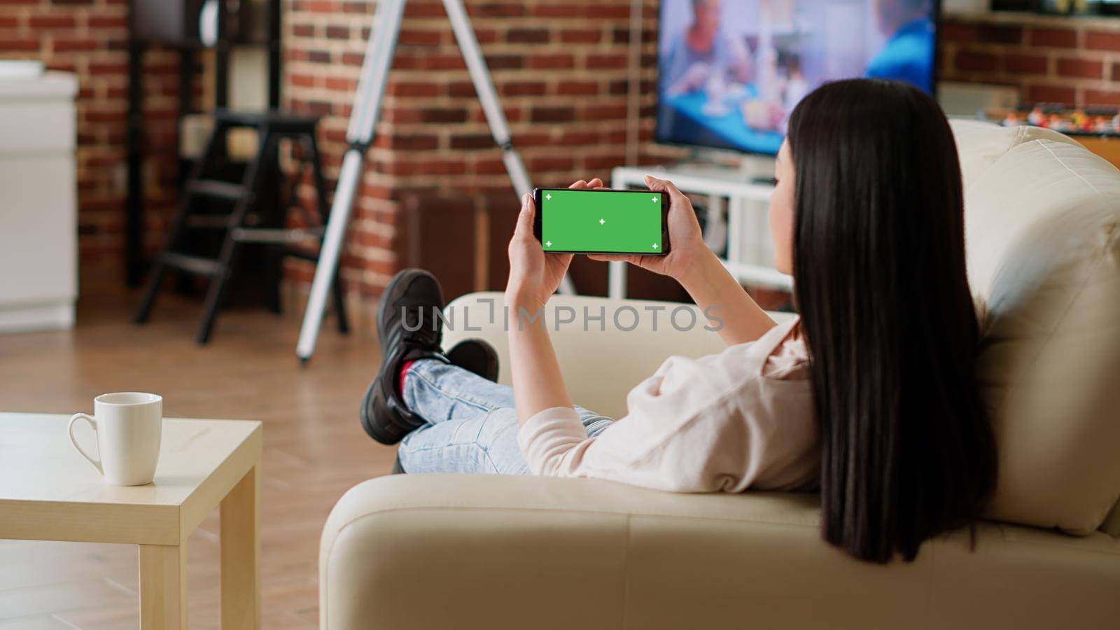 Relaxed person with modern touchscreen mobile phone having chroma key isolated display by DCStudio