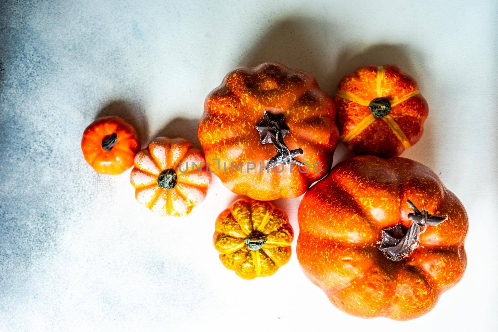 Autumnal frame concept with pumpkins on concrete background