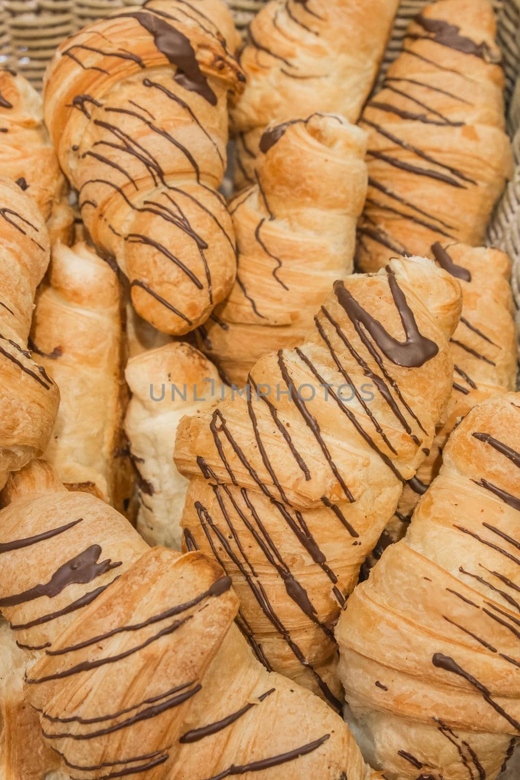 Fresh croissants with chocolate filling background baking bakery counter by AYDO8