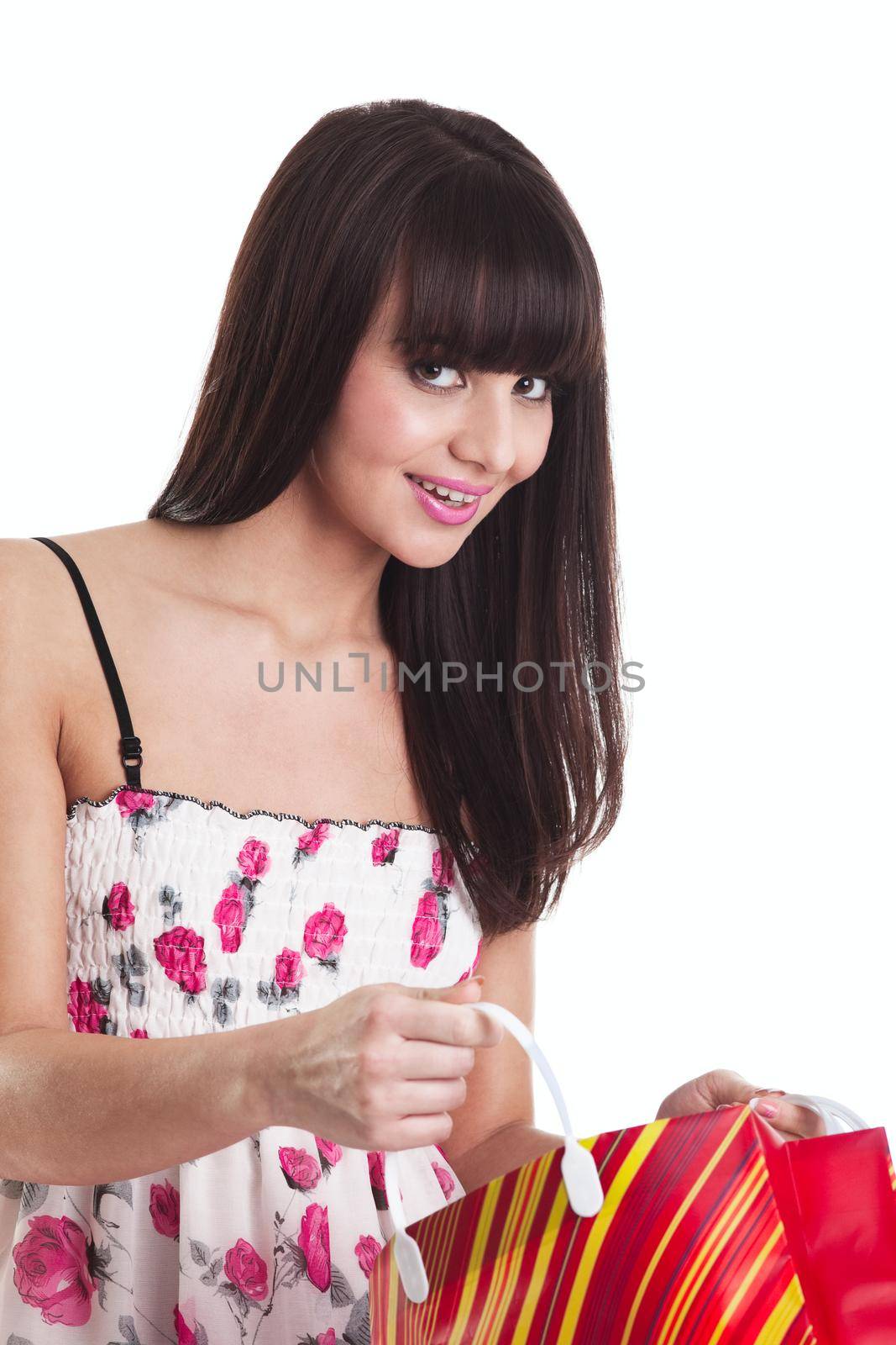 Young girl with present bag look at you and smile isolated