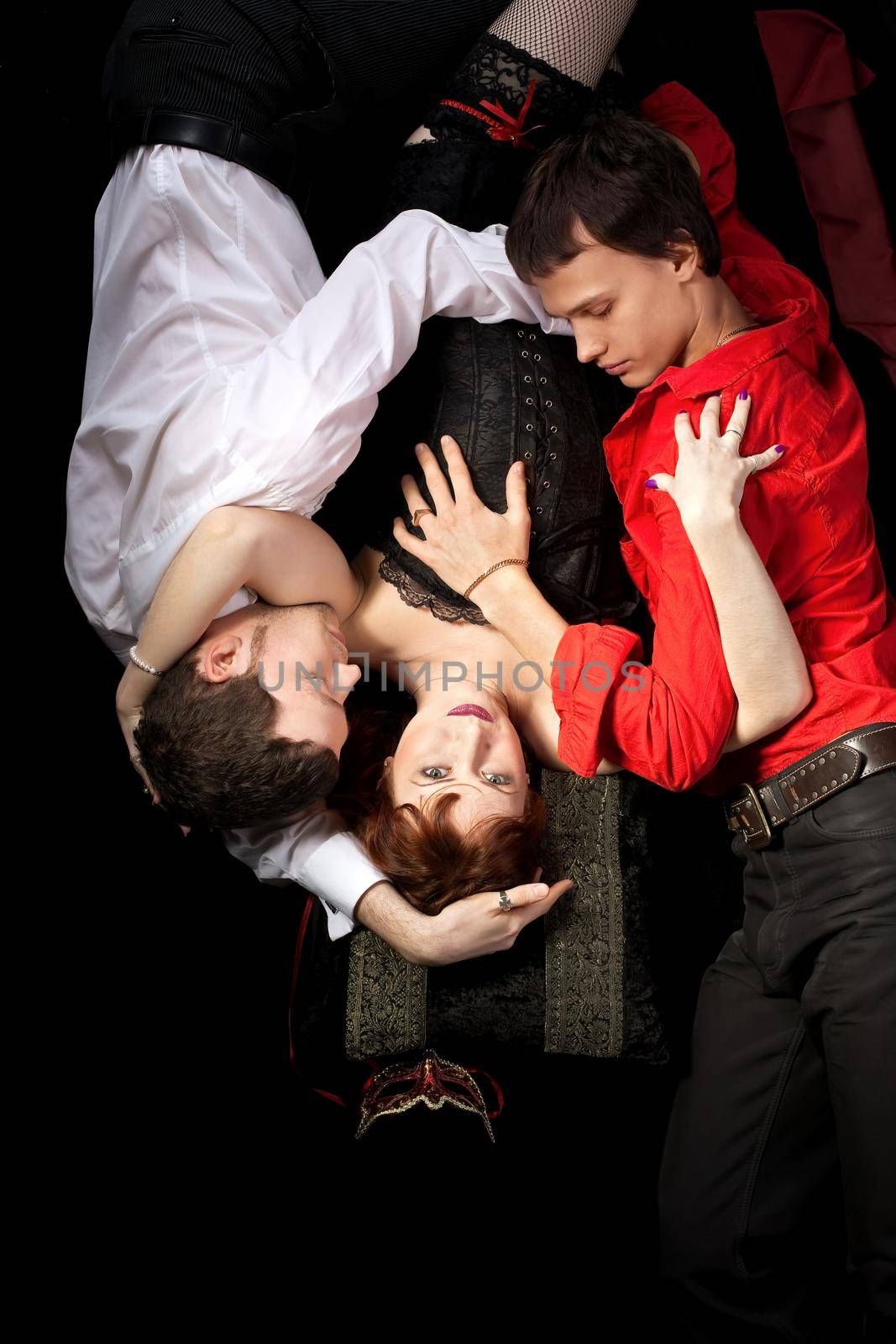 red woman in mask and two men - decadence scene