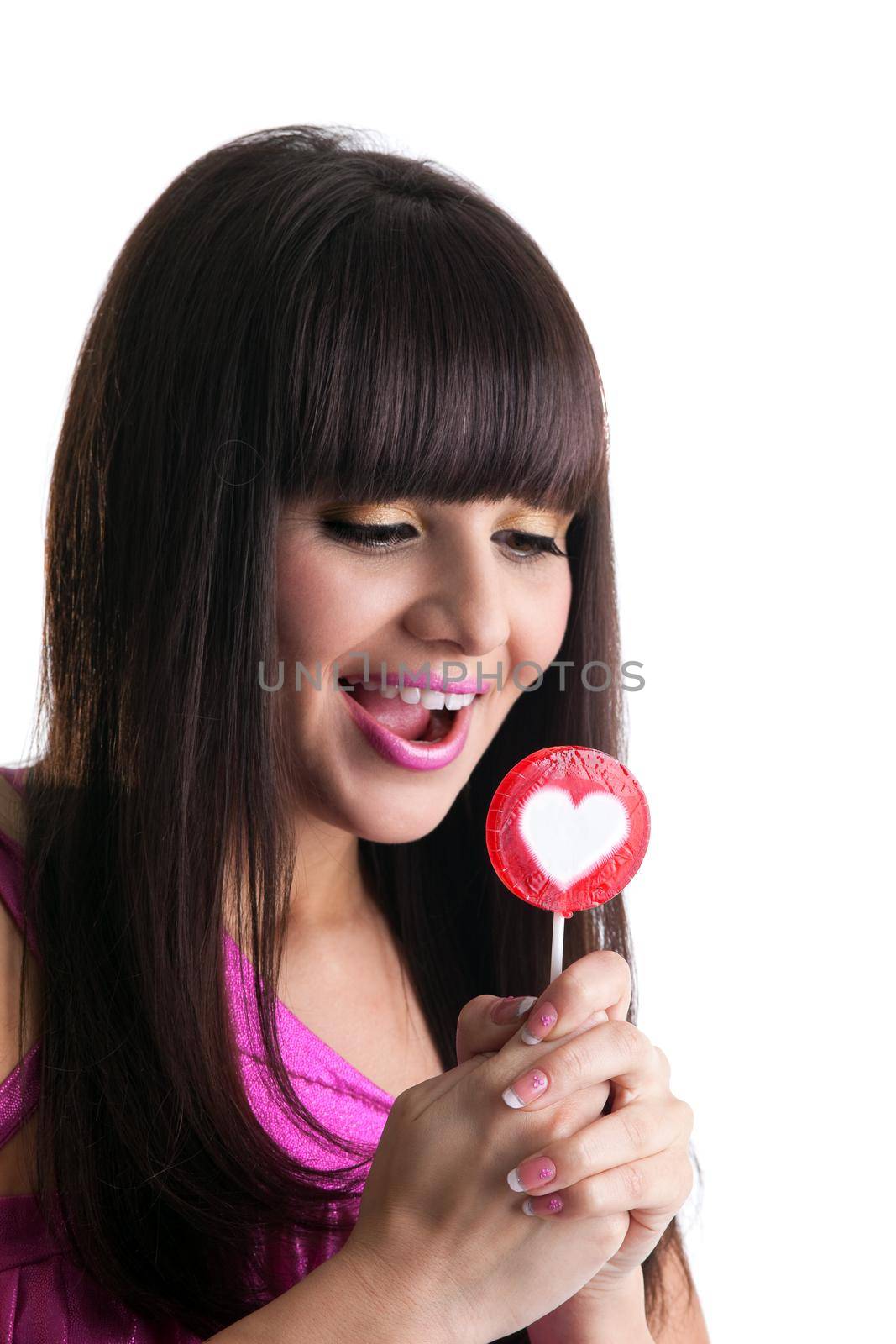 young brunette woman look at heart candy and smile