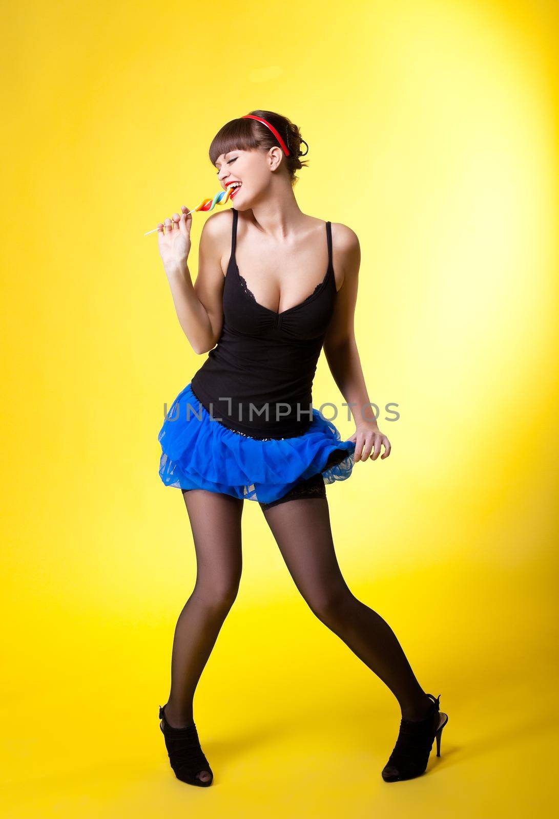 Beauty woman with candy pinup style on yellow
