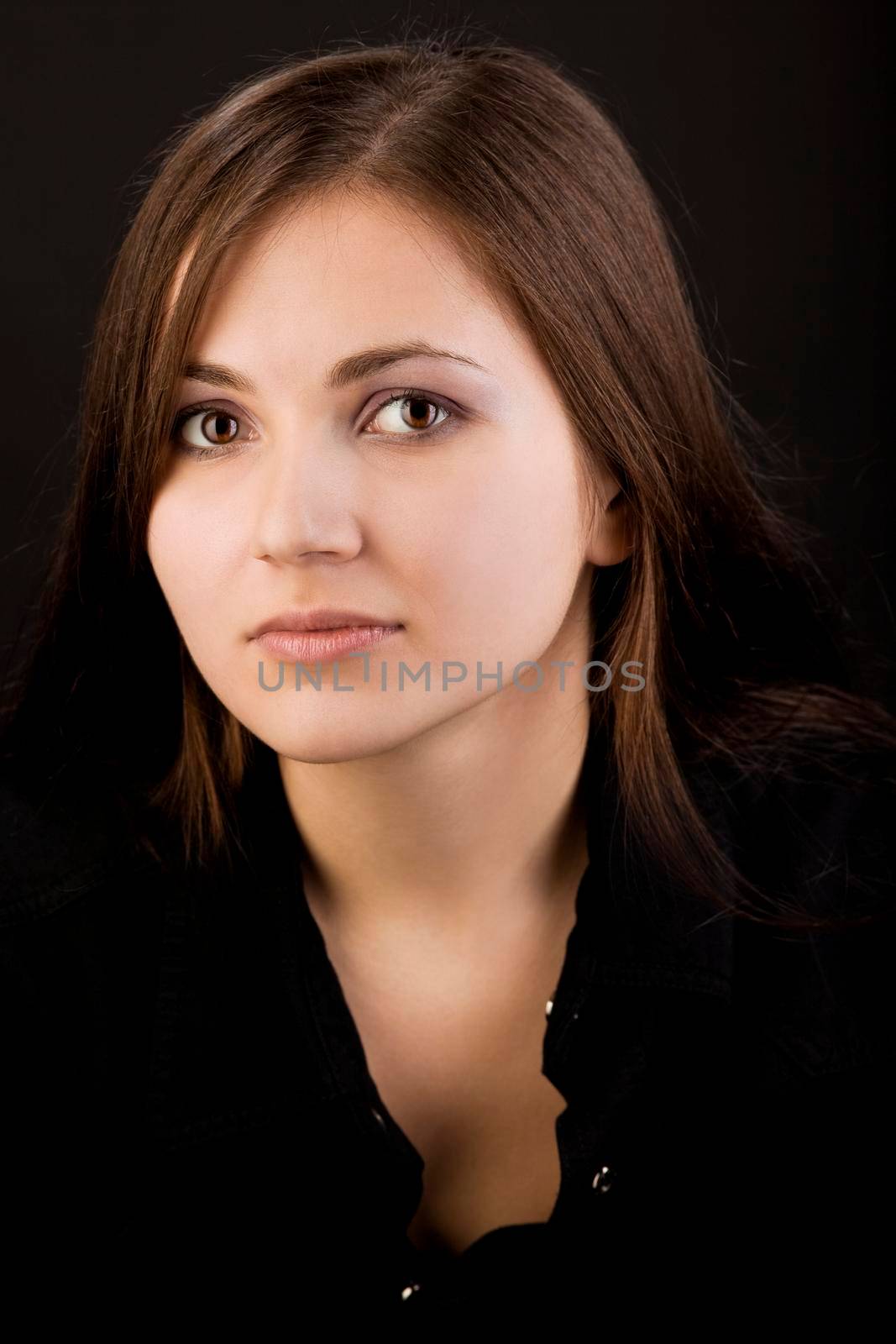 Young unhappy woman in black shirt look at you