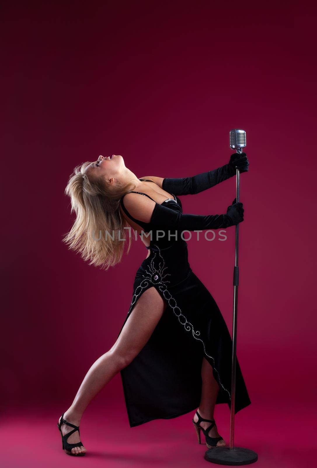 Young beauty Singer With Microphone on red by rivertime