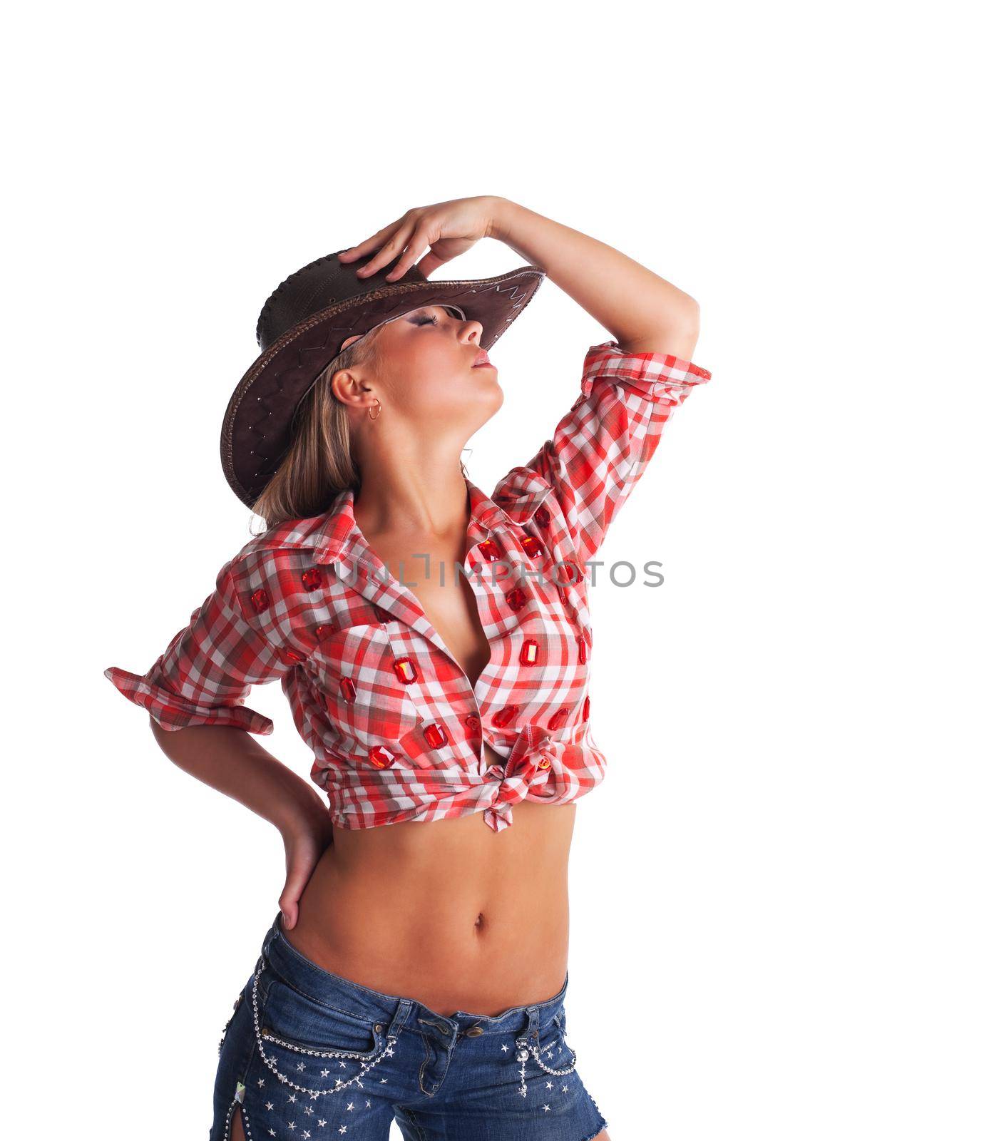 sexy young cowgirl take hand on hat isolated by rivertime