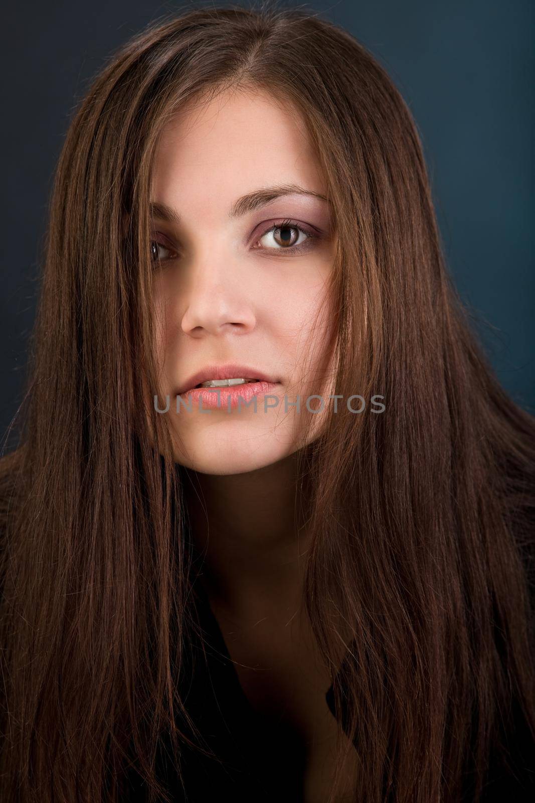 Young woman with long hair in sad look at you