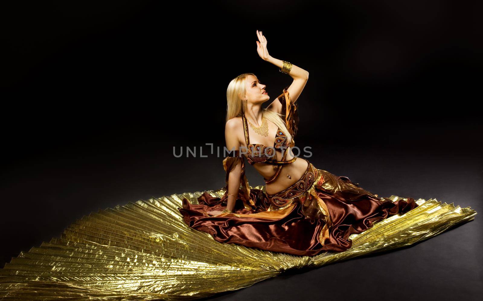Young beauty woman lay on gold saber by rivertime