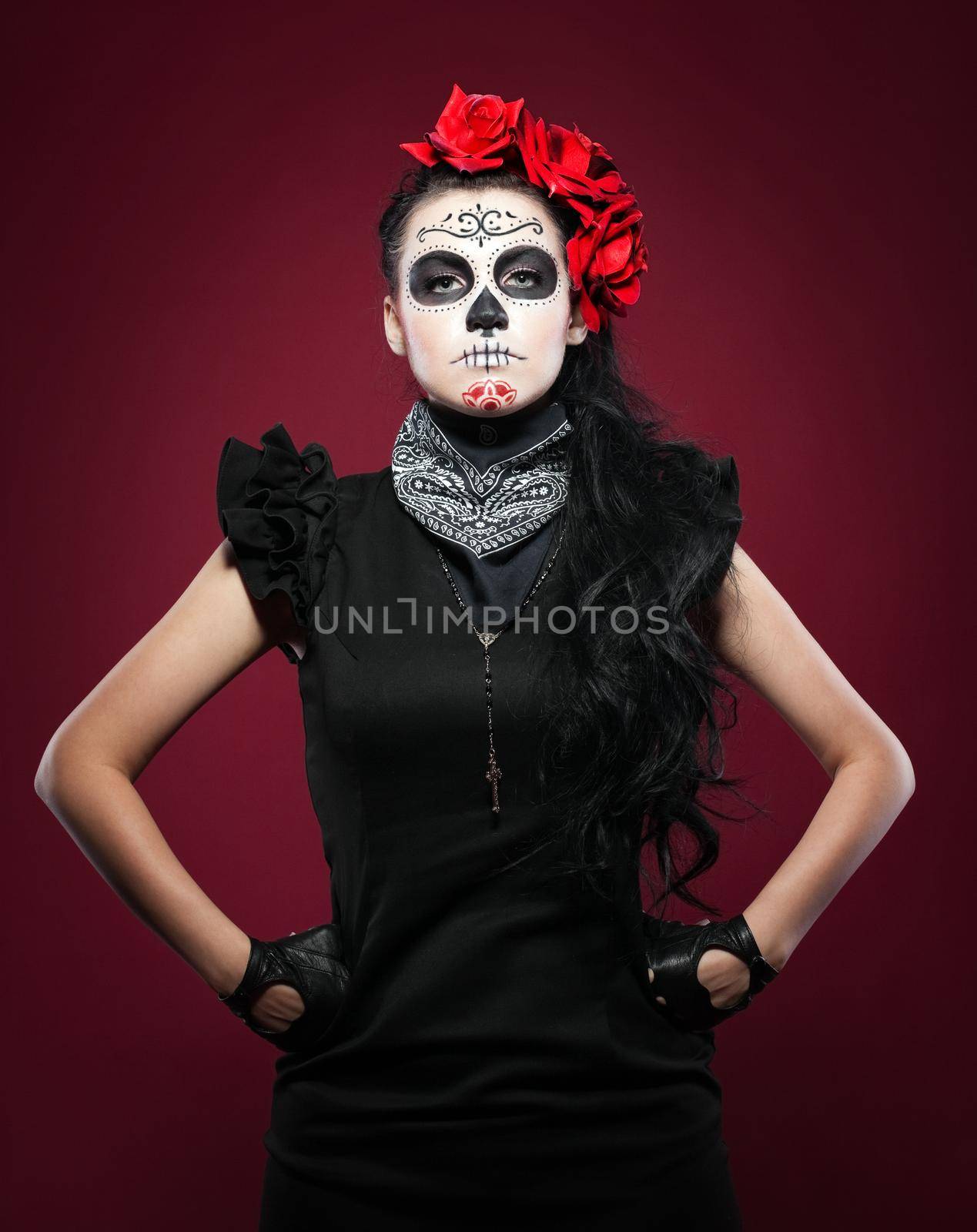 Young girl in day of the dead mask on red by rivertime