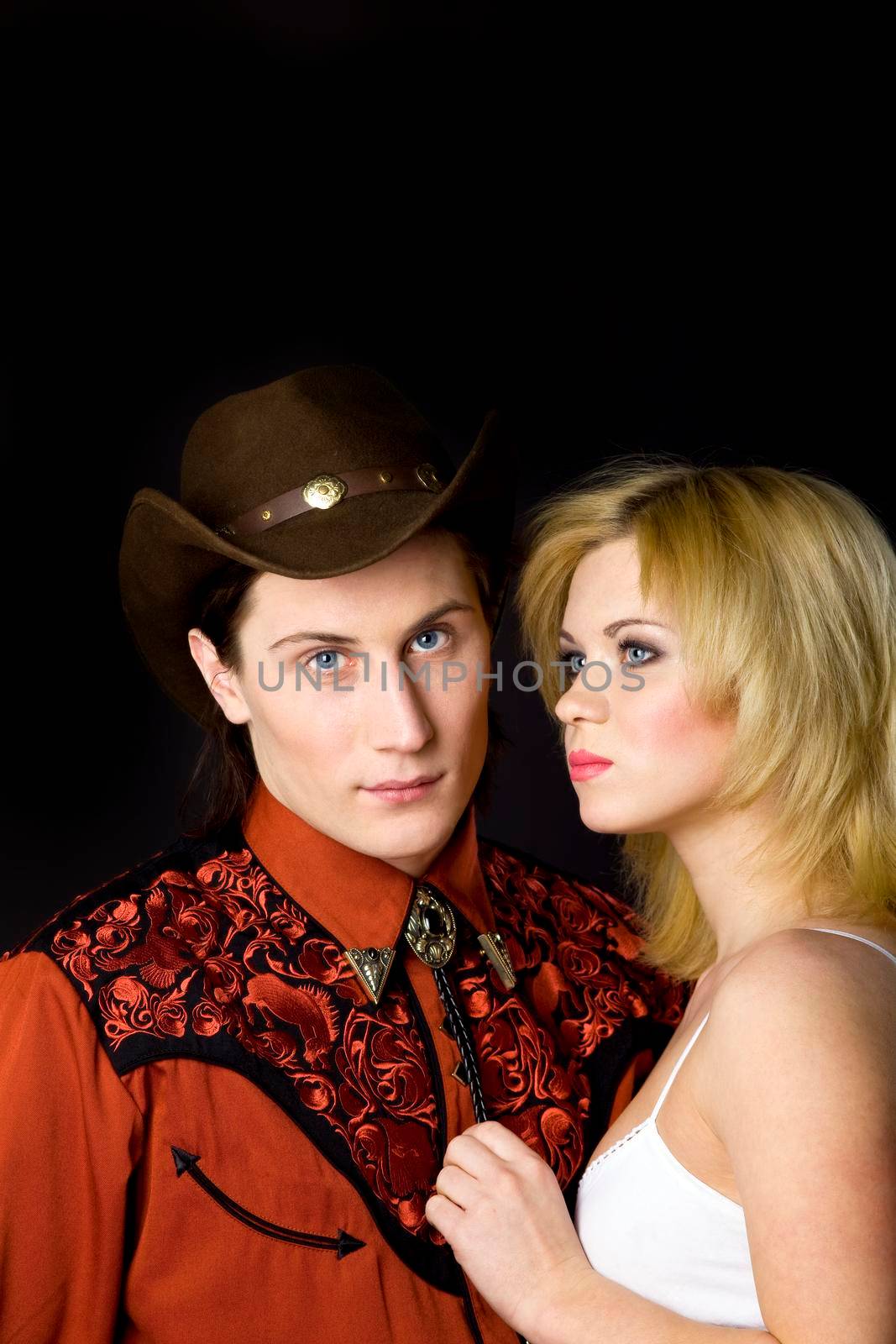 Young boy and girl studio shot cowboy style