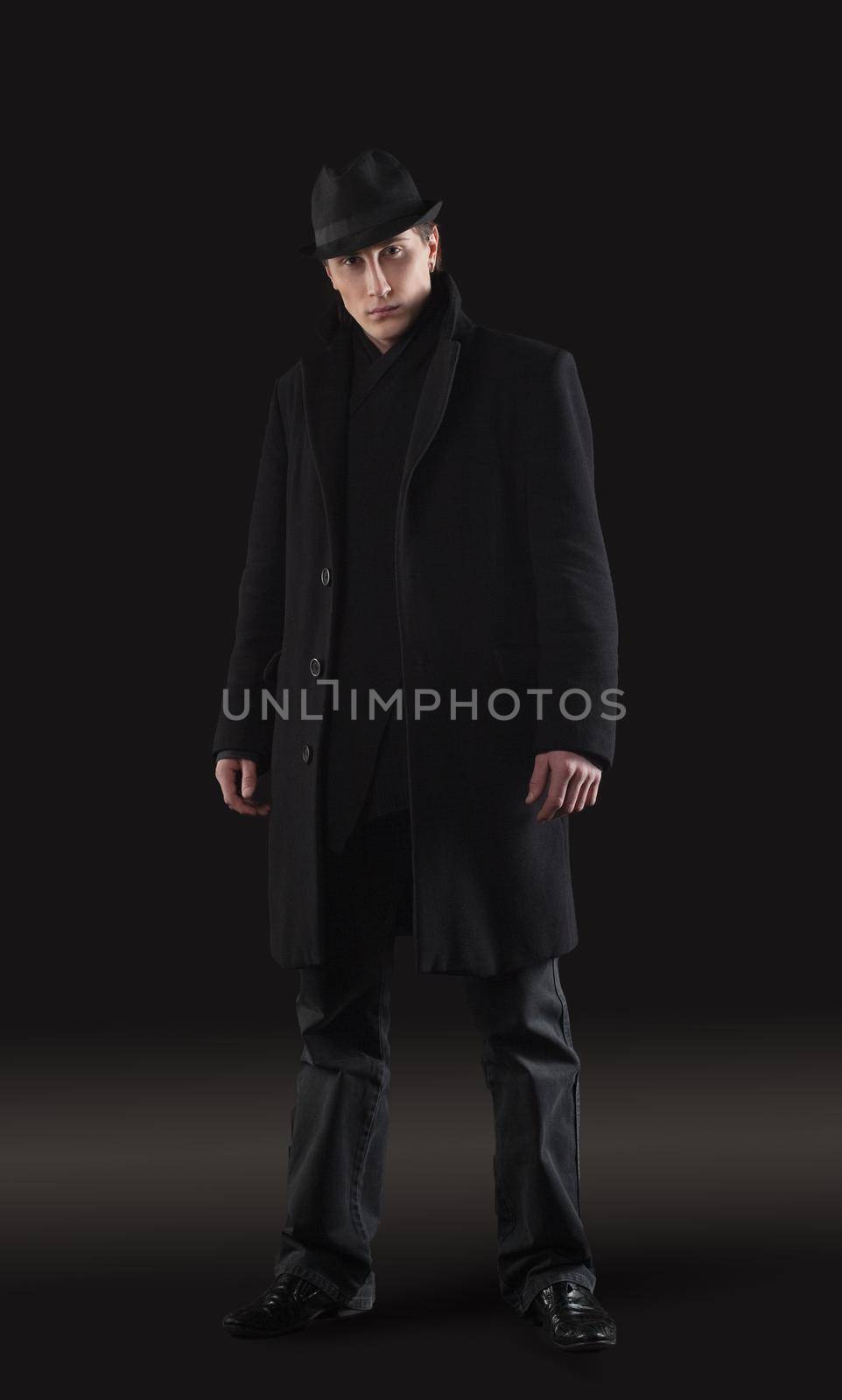 Man in black cloth stand - studio shot