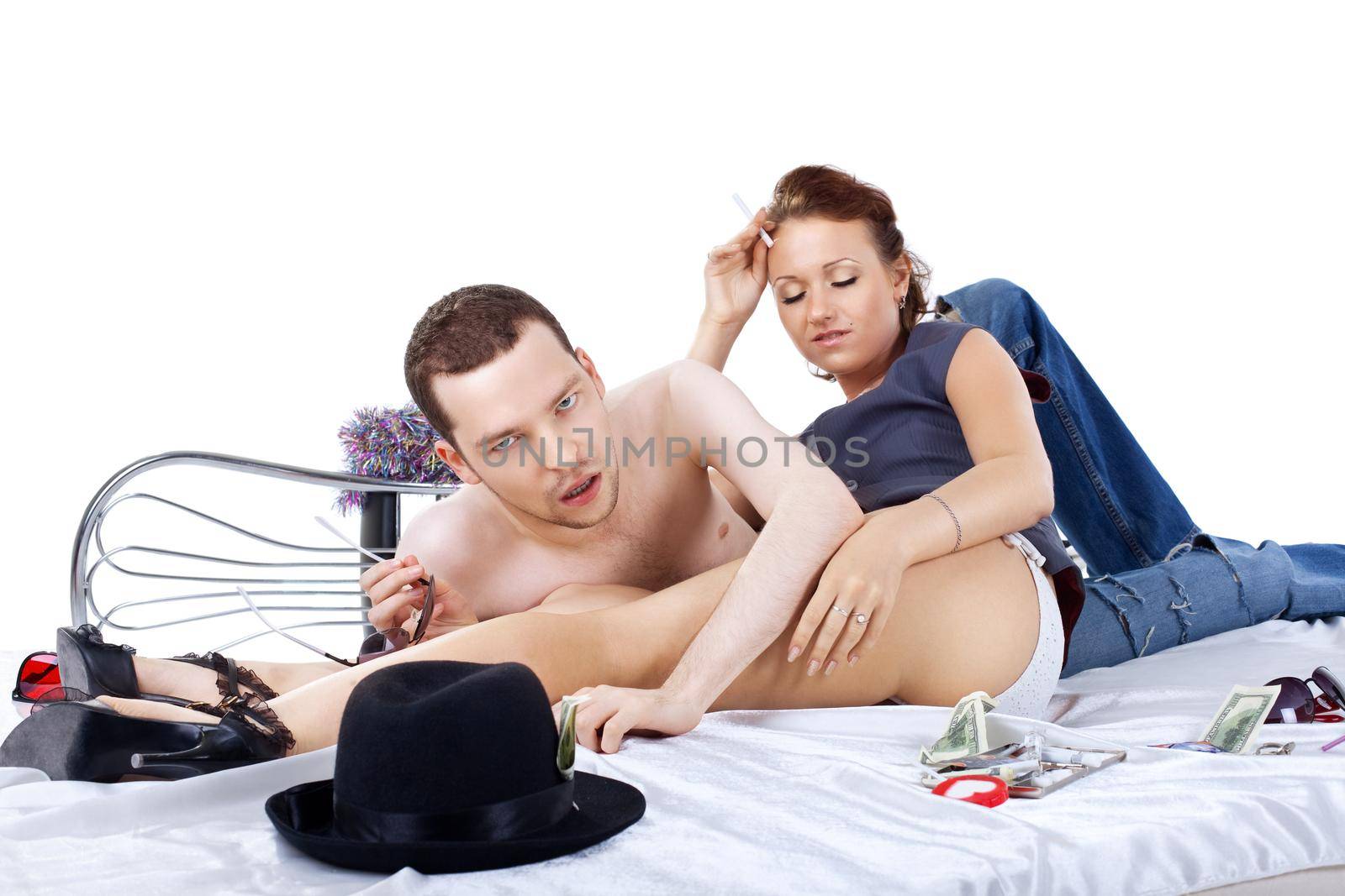 adult man and woman on bed at morning after party by rivertime