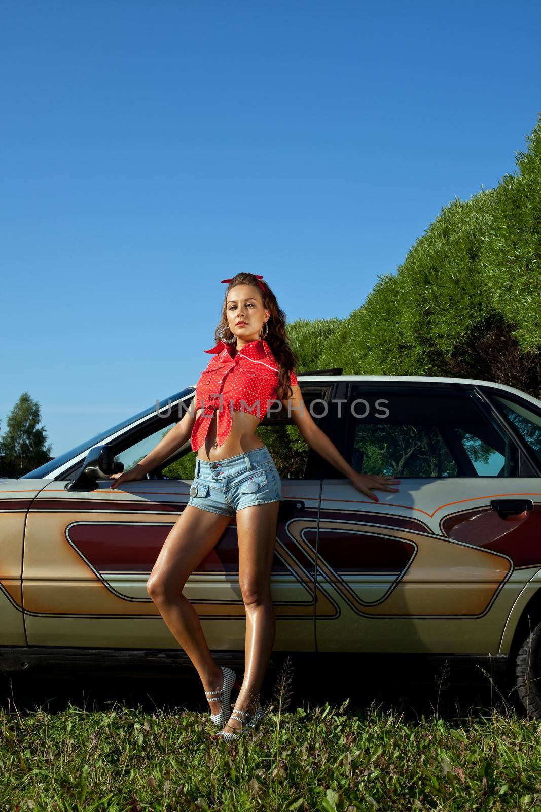 Sexy young woman stay near retro graffiti car by rivertime