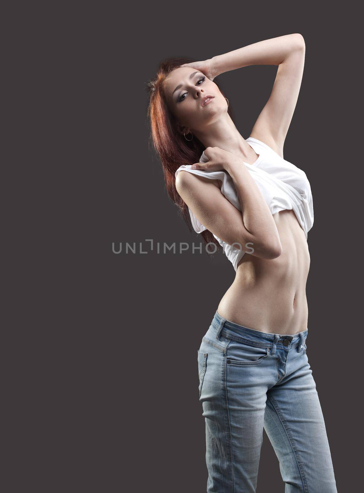 sexy young woman in jeans and tank top undress by rivertime