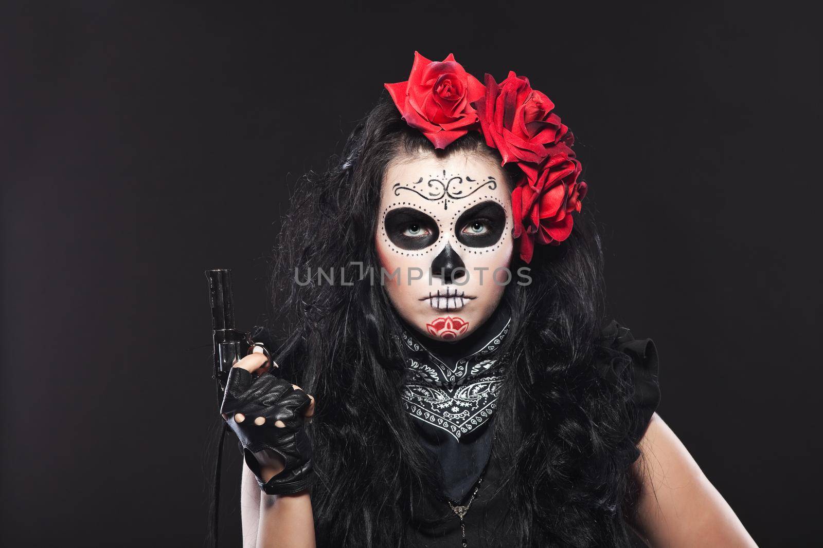 Serious woman in day of the dead mask with gun by rivertime