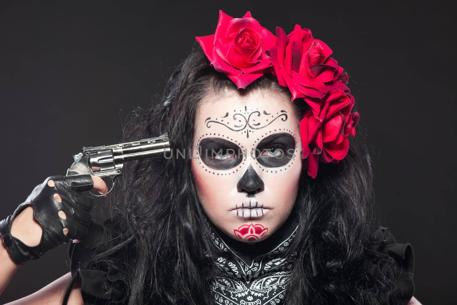 Young girl in day of the dead mask with gun by rivertime