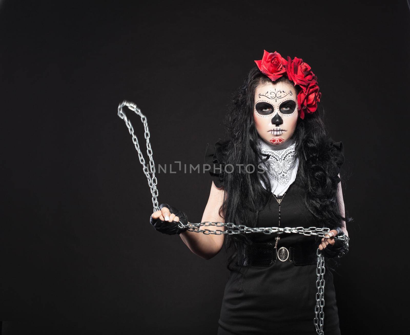 Depressed woman in day of the dead mask with chain by rivertime