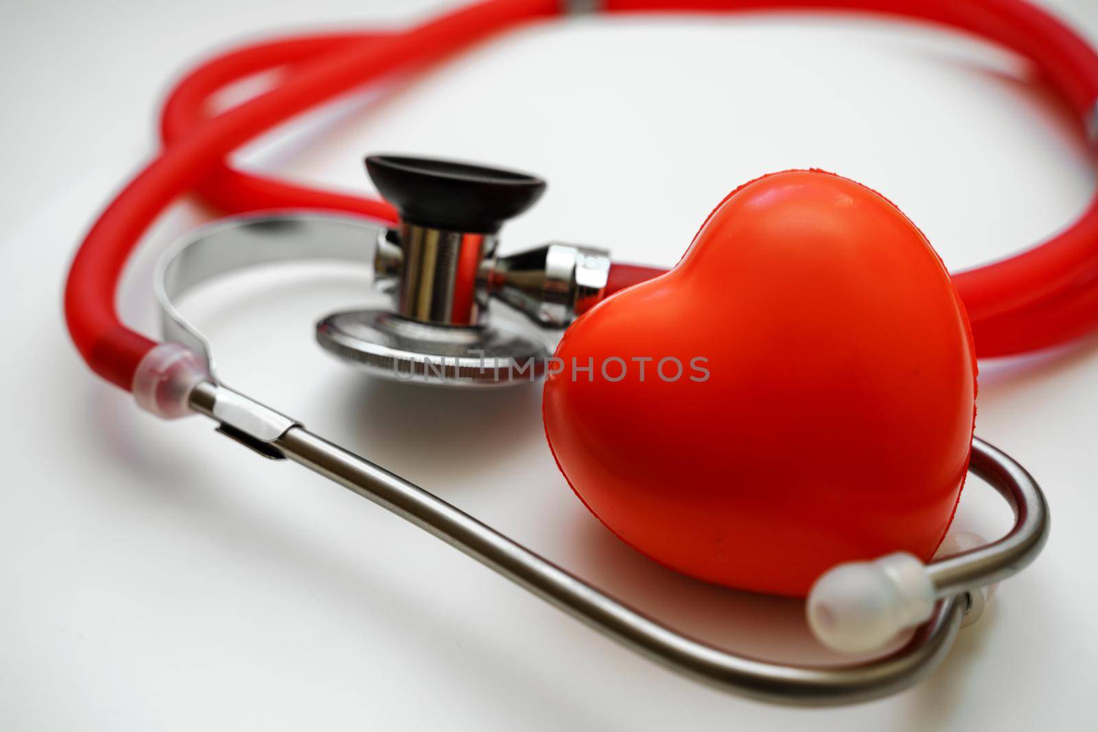 Stethoscope and red heart on white background, heart health, health insurance concept.