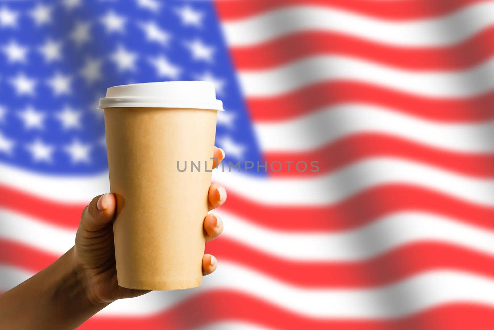 Closeup of American flag with coffee paper cup. by Andelov13