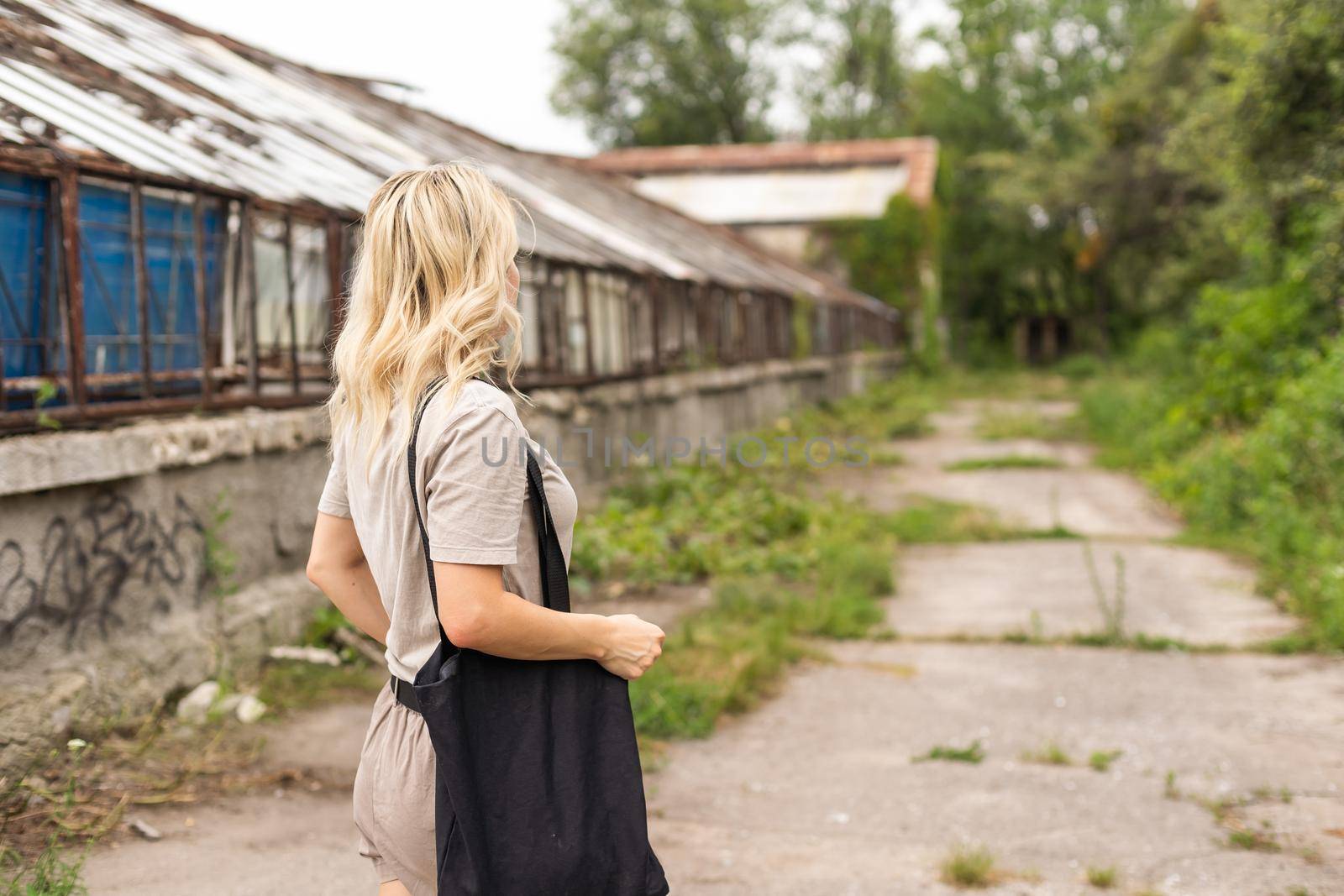 Girl is holding black cotton eco tote bag, design mockup by Andelov13