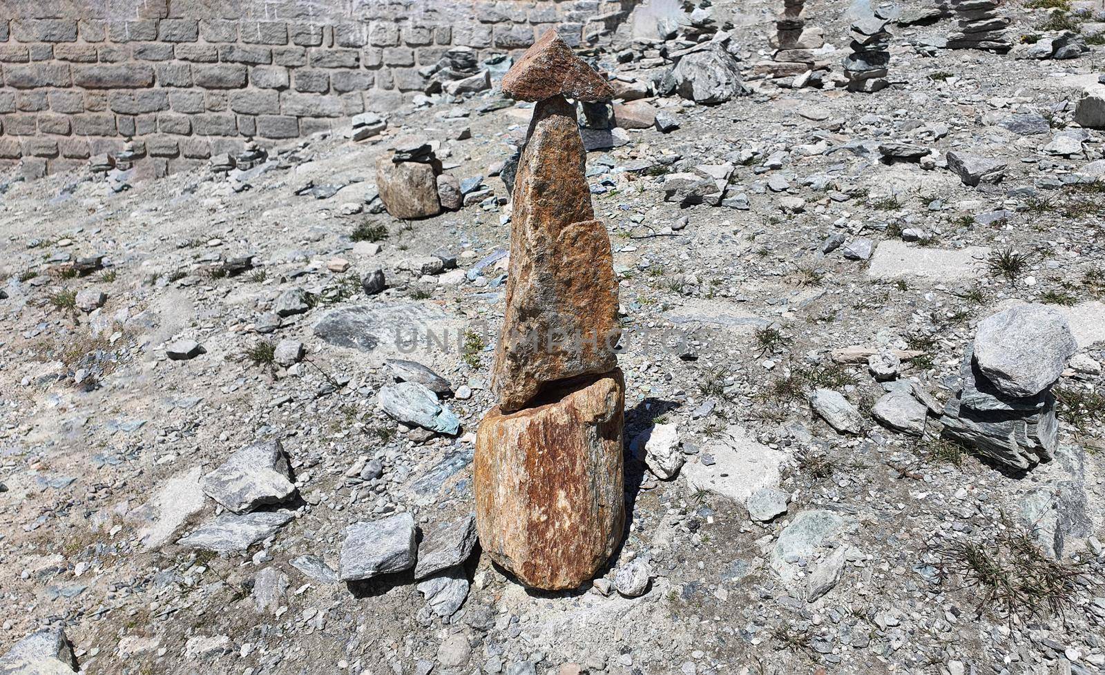 Stack of stones on top of the mountain. Pile of rocks stone and mountains. Balanced stone pyramid or Stacked stone or mountain stones tower. Stones arranged for meditation. Represent spirit of Zen.