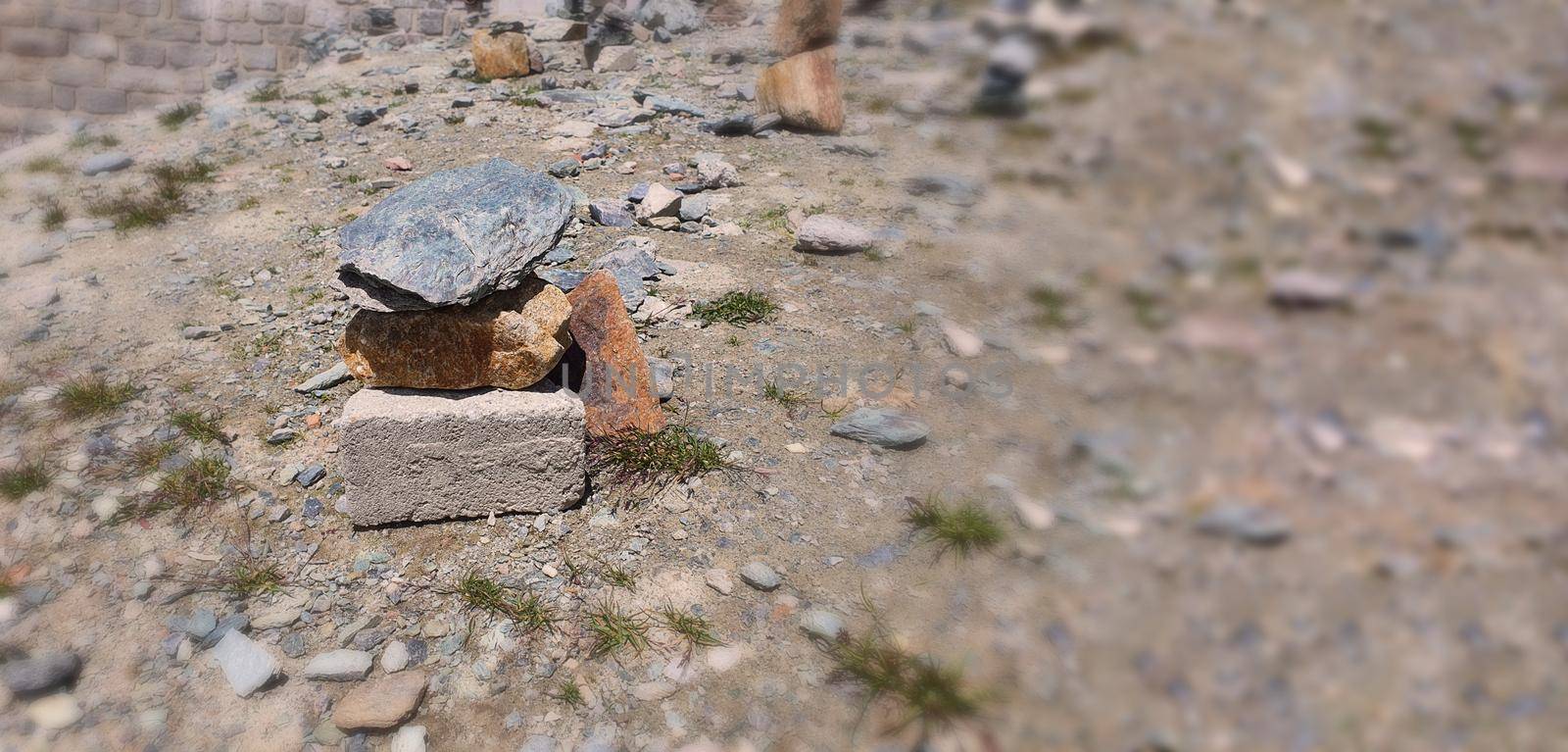 Stack of stones on top of the mountain. Pile of rocks stone and mountains. Balanced stone pyramid or Stacked stone or mountain stones tower. Stones arranged for meditation. Represent spirit of Zen.