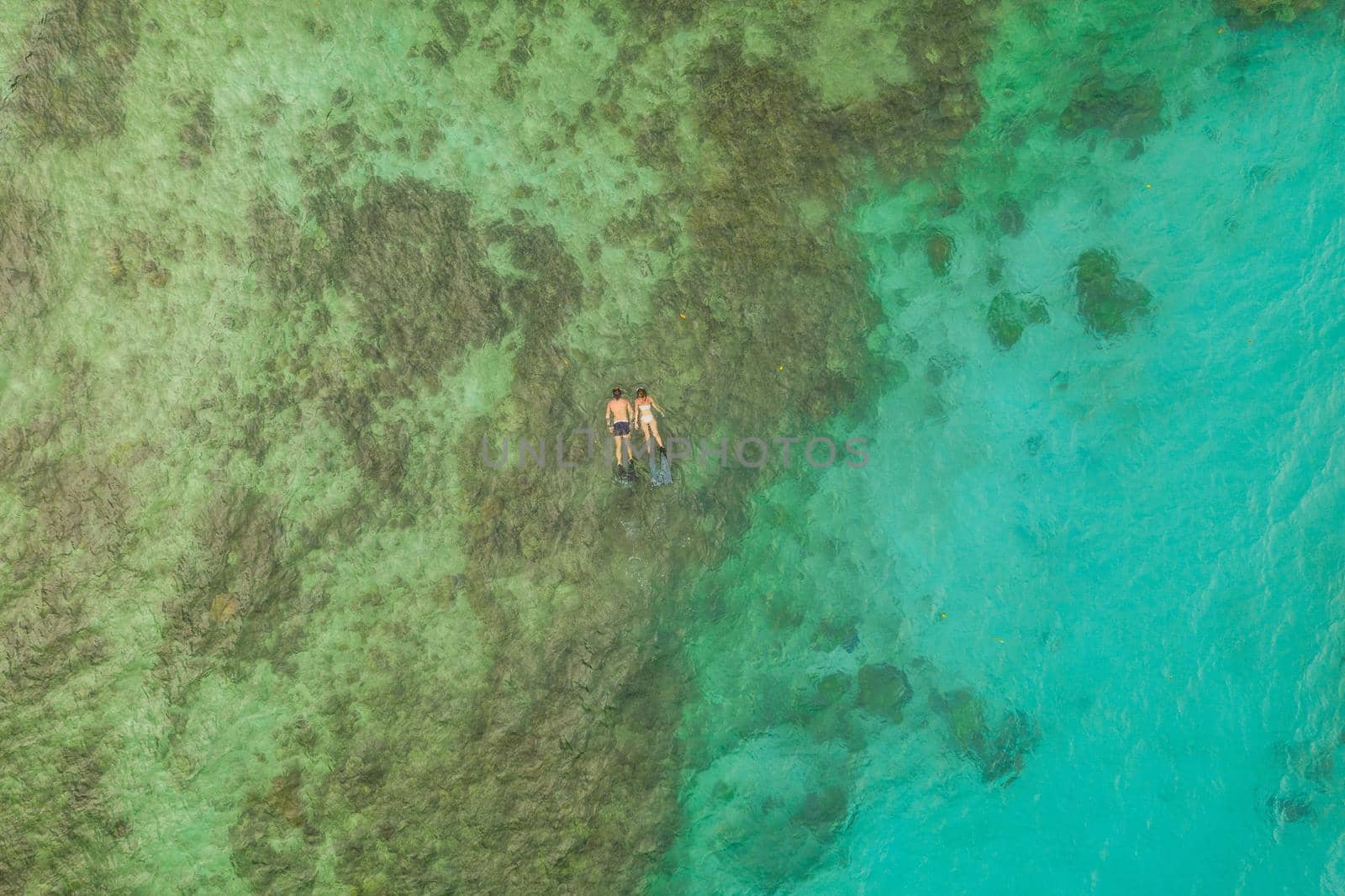 Floating in a sea of happiness. High angle shot of an unrecognizable couple swimming in the waters of Raja Ampat