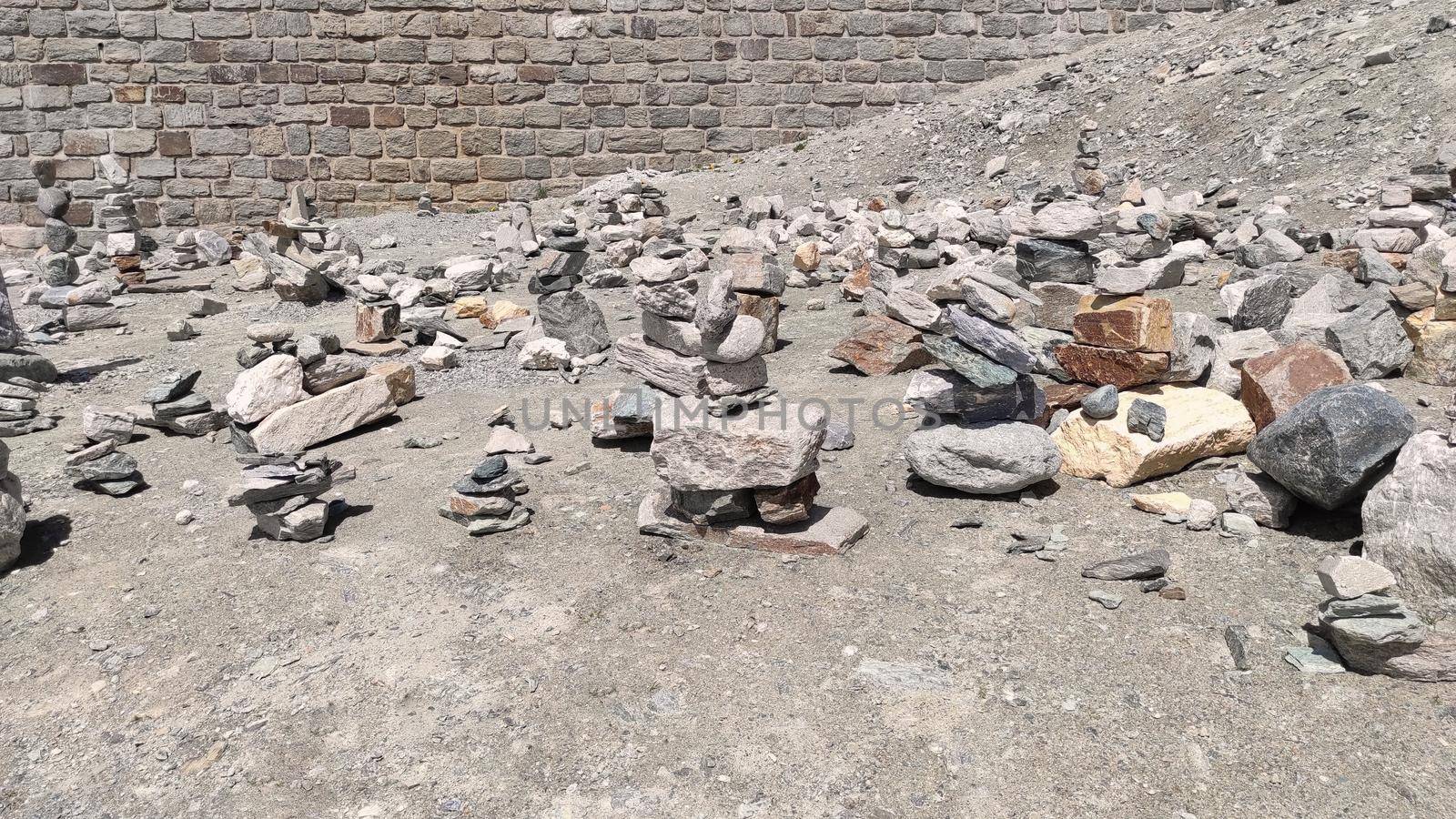 Stack of stones on top of the mountain. Pile of rocks stone and mountains. Balanced stone pyramid or Stacked stone or mountain stones tower. Stones arranged for meditation. Represent spirit of Zen.