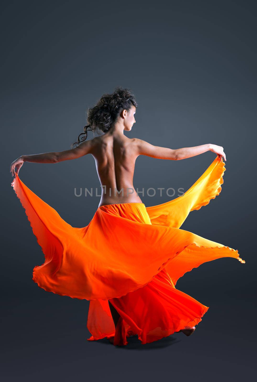 Beauty girl with naked spine dance in orange cloth by rivertime