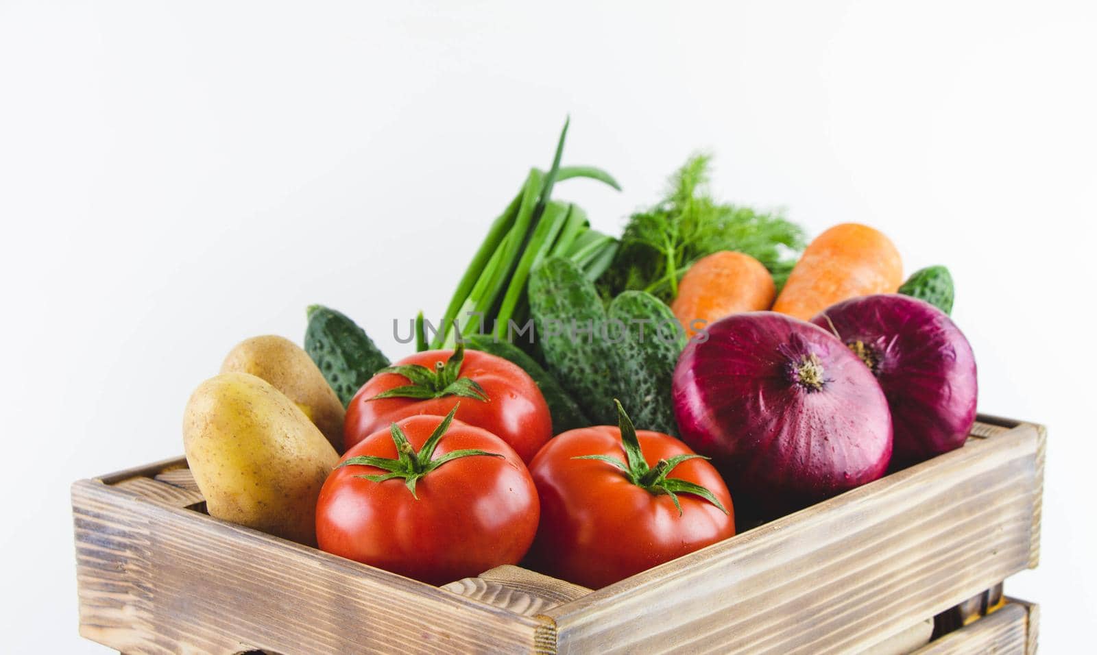 Basket with vegetables. Tomatoes, onions, labeling, potatoes, cucumbers and dill.