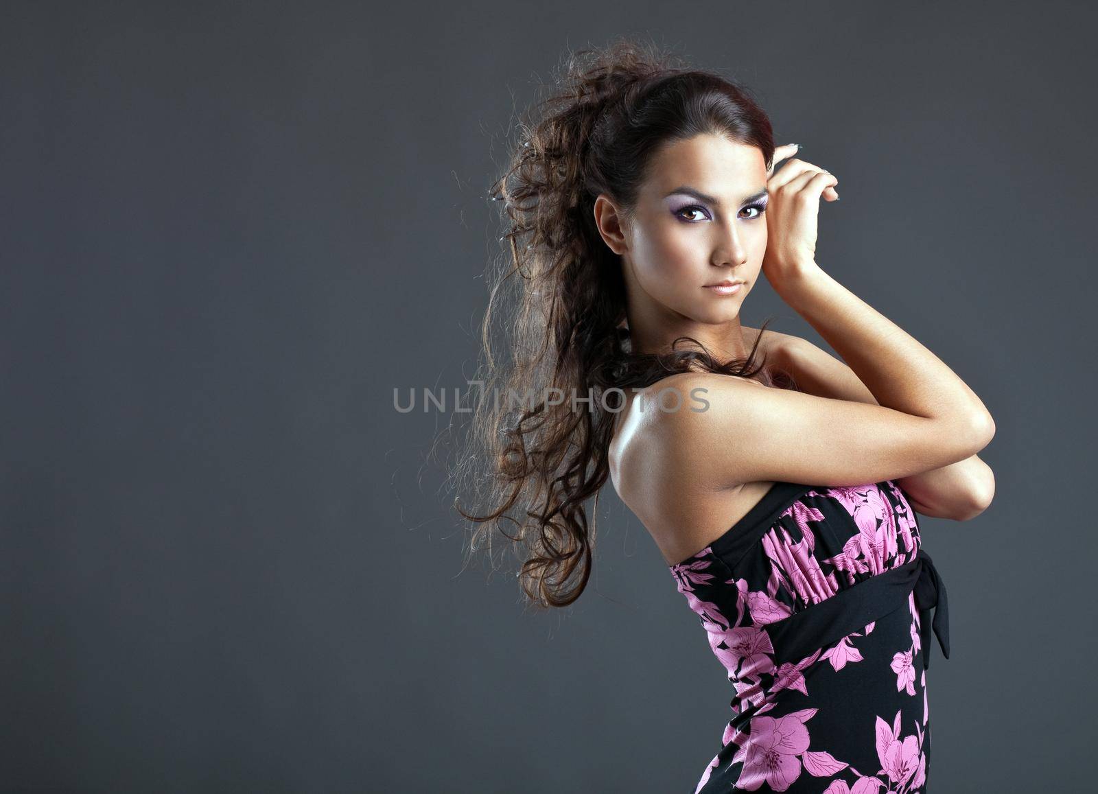 Beauty young woman with long hair posing at camera