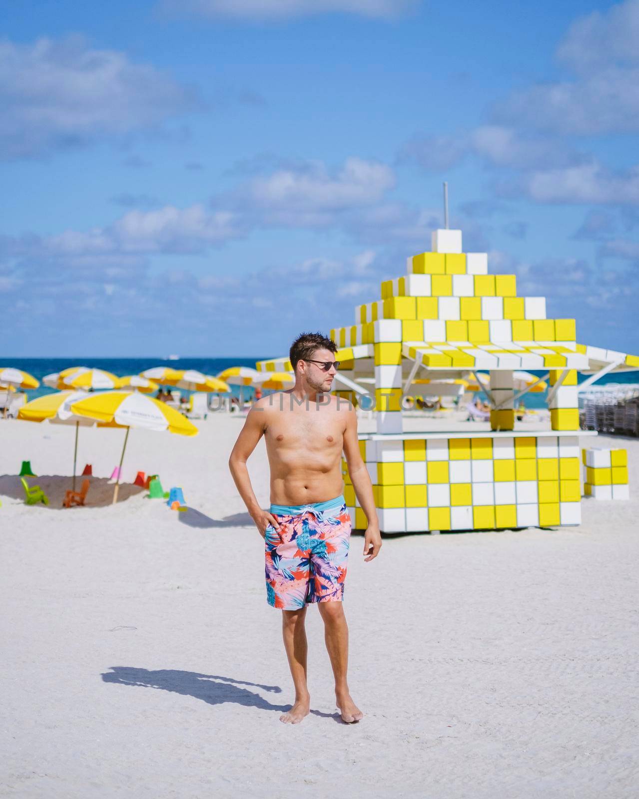 Miami beach, young men on the beach at Miami beach, lifeguard hut Miami beach Florida by fokkebok