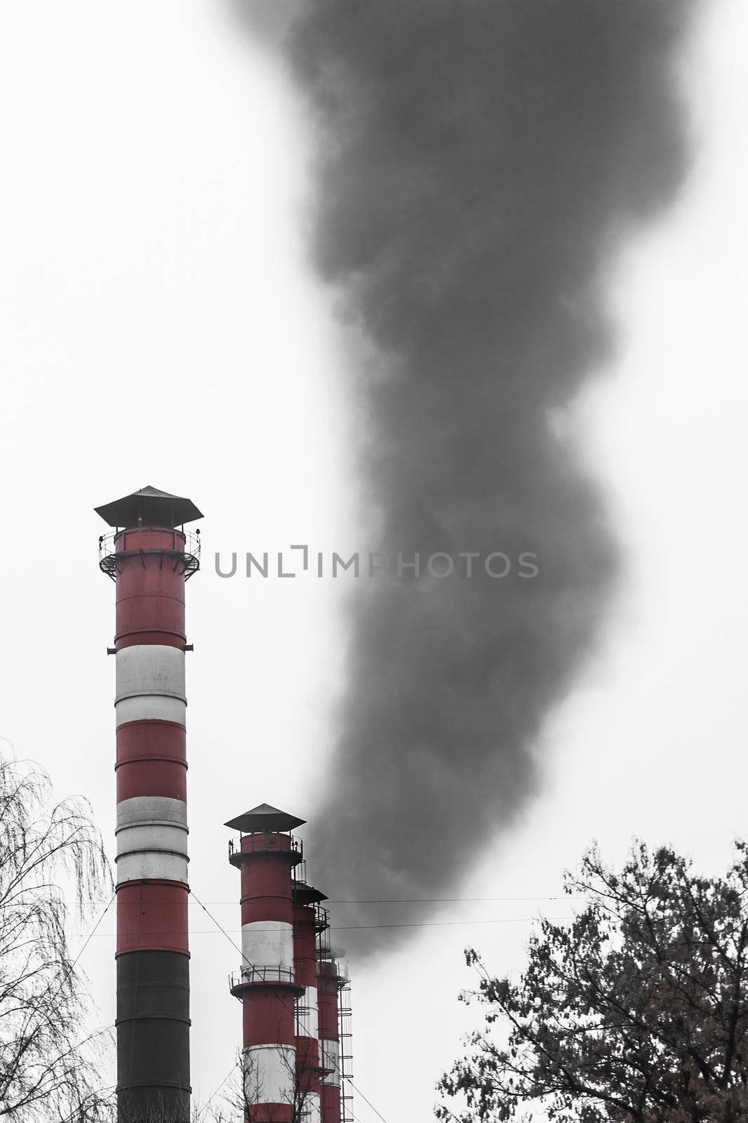 Pollution of the environment, air and ecology are global problems. Toxic smoke from the dirty chimney of an industrial plant is released into the atmosphere by AYDO8