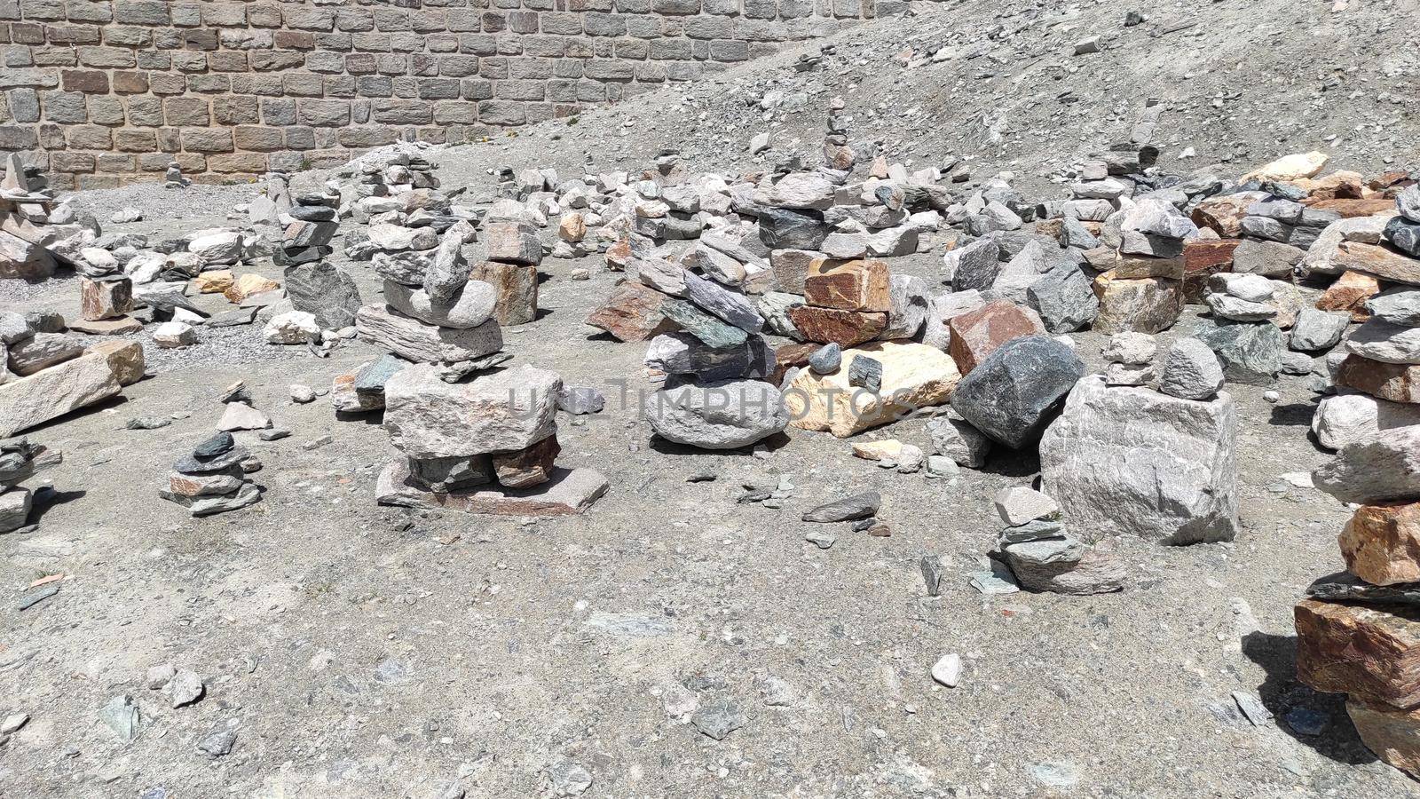 Stack of stones on top of the mountain. Pile of rocks stone and mountains. Balanced stone pyramid or Stacked stone or mountain stones tower. Stones arranged for meditation. Represent spirit of Zen.