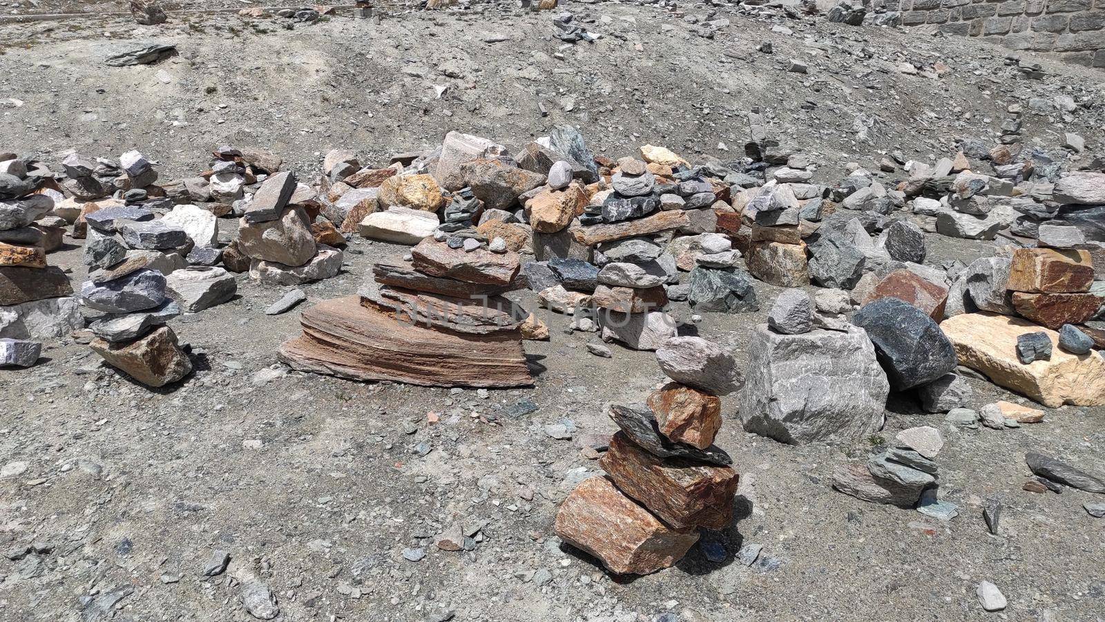 Stack of stones on top of the mountain. Pile of rocks stone and mountains. Balanced stone pyramid or Stacked stone or mountain stones tower. Stones arranged for meditation. Represent spirit of Zen.