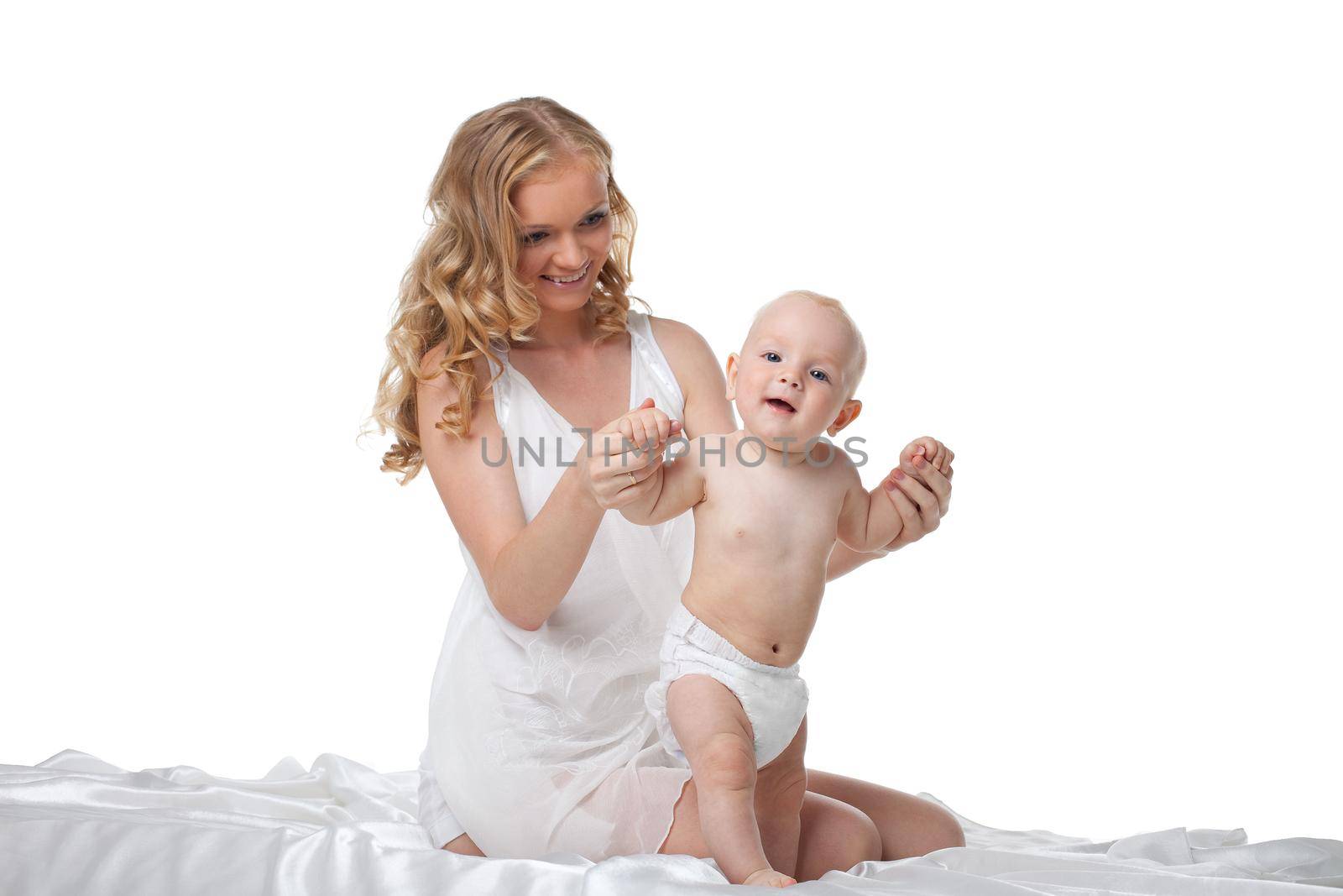 Beauty blond mother play with son in bed by rivertime