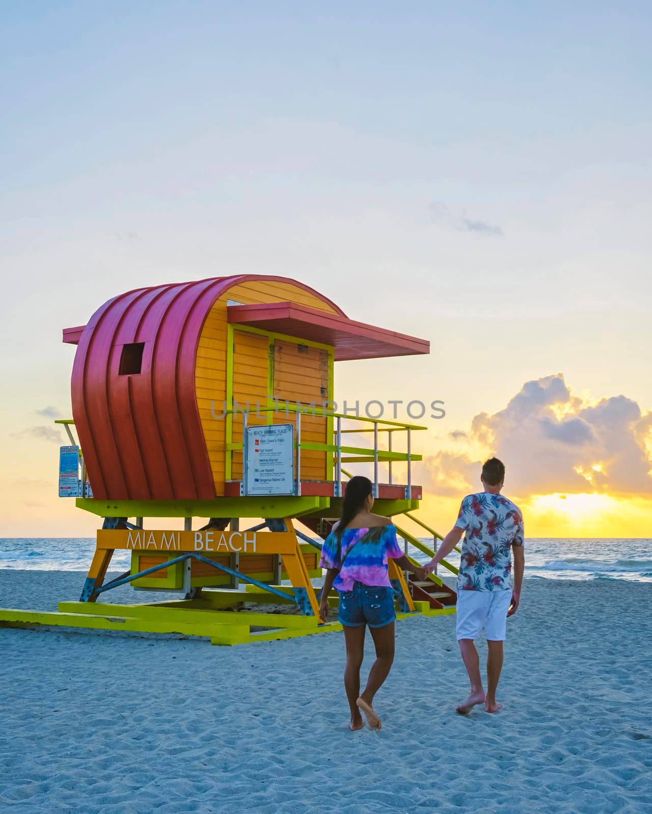 Miami beach, couple on the beach at Miami beach, life guard hut Miami beach Florida sunrise by fokkebok