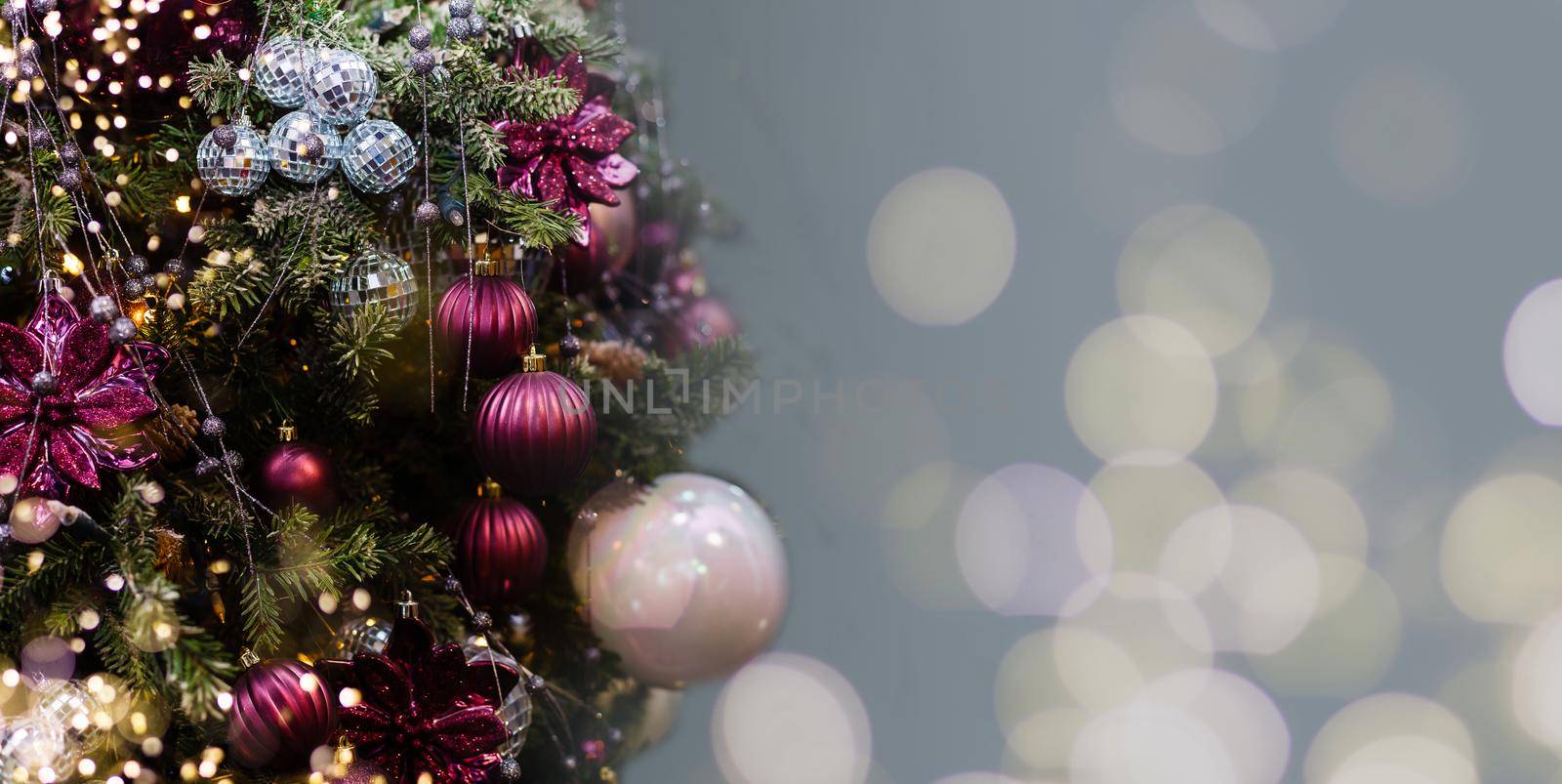 banner. blue christmas decoration, postcard. on the tree a snowflake, balls and a garland.